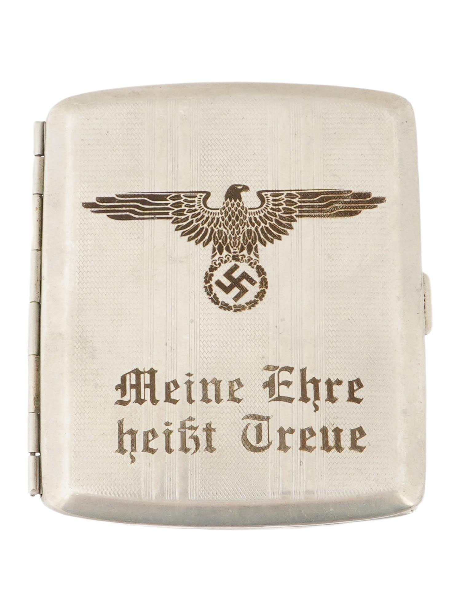 WWII TYPE GERMAN WWII SS CIGARETTE CASE WITH SS MOTTO: A WWII type German WWII SS cigarette case with SS motto Loyalty Is My Honor. The front of the case has a patterned texture. It features an embossed image of a Nazi eagle perched above a swastika withi