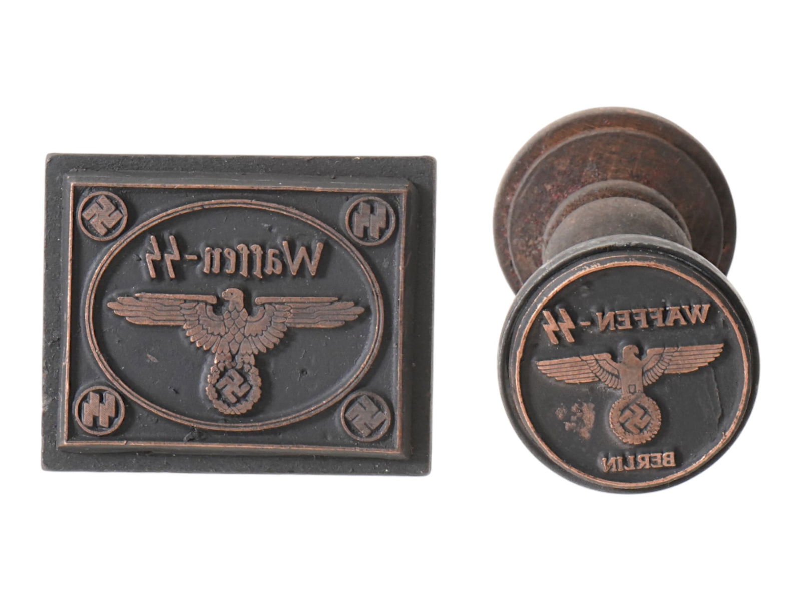 TWO WWII TYPE GERMAN WAFFEN SS INK HAND STAMPS: A group of two WWII type Nazi German wood and metal ink hand stamps, including a stamp Waffen SS, and a stamp Waffen SS Berlin. Both, rectangular and round hand stamps depicting a German Nazi eagle ho