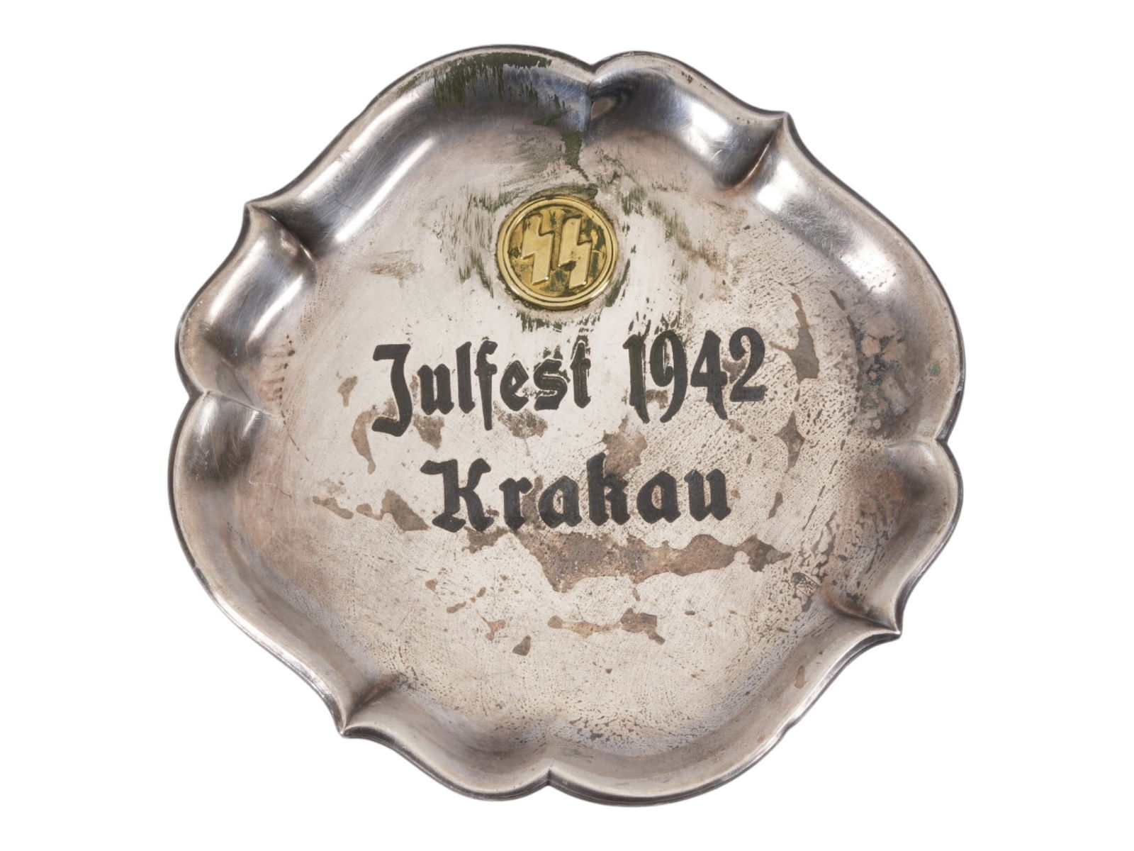 WWII TYPE NAZI GERMAN THIRD REICH METAL ASHTRAY 1942: A WWII-type Nazi German Third Reich metal ashtray. The ashtray features relief images of SS runes in gold tone and the inscription Julfest 1942 Krakau, in English: Christmas festival in Krakow, 1942.