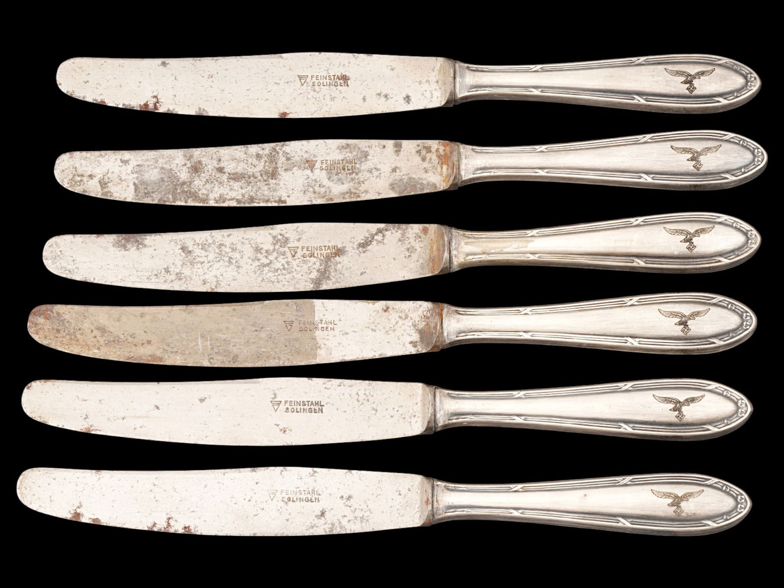 WWII MODEL GERMAN KNIVES FROM LUFTWAFFE PILOTS CANTEEN: A set of six WWII model German knives from a Luftwaffe pilots canteen. Each knife is engraved with a Nazi eagle clutching a swastika on the handle and marked with Feinstahl Solingen on the blade. Worl