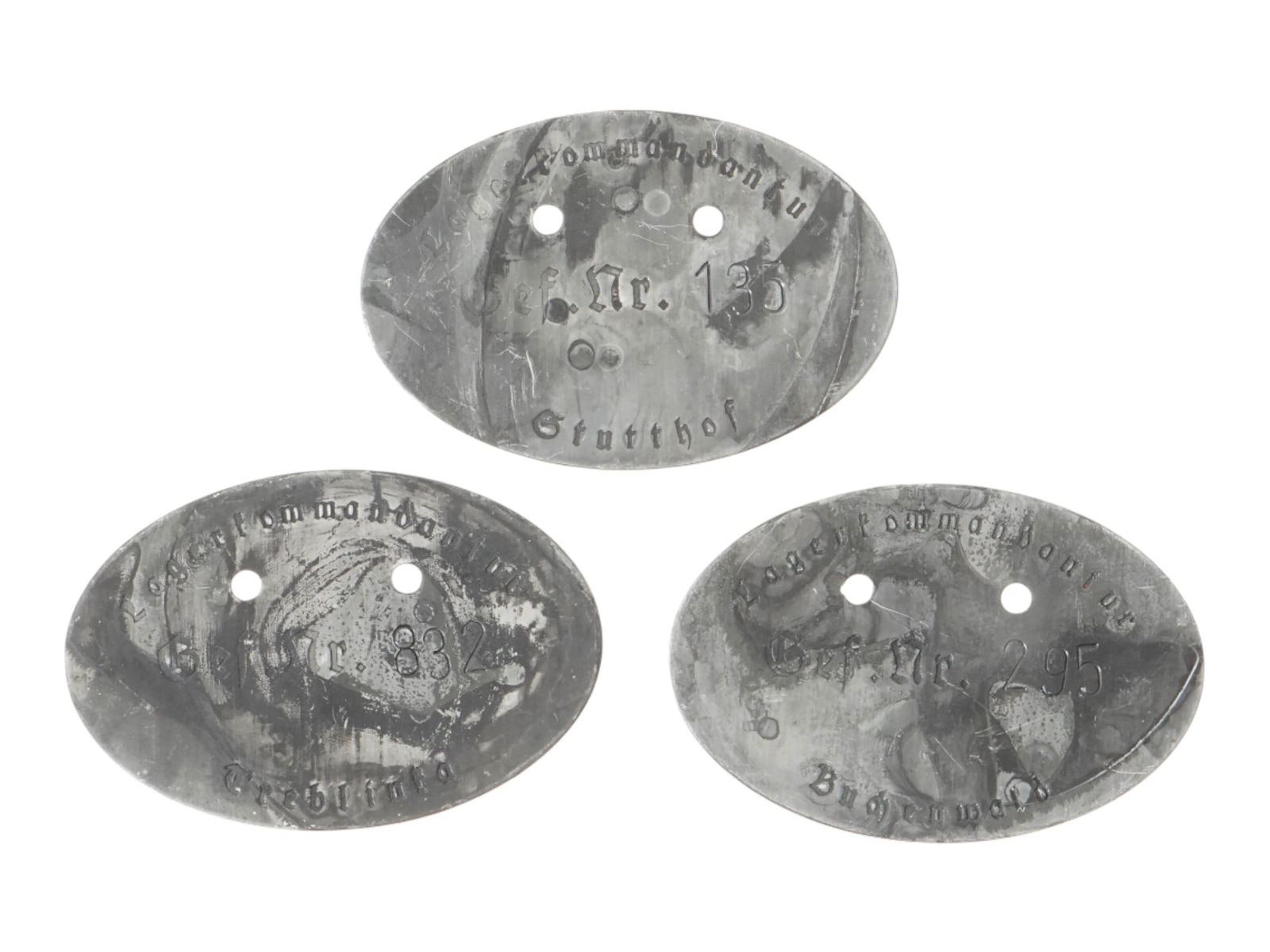 LOT OF WWII TYPE SS CAMPS SOLDIER DOG TAG ID DISCS: A lot of three WWII type Nazi German SS concentration camps guards soldier ID discs, so called Dog Tag including Treblinka, Buchenwald, Stutthof. The tags contain the soldiers personal number, and the