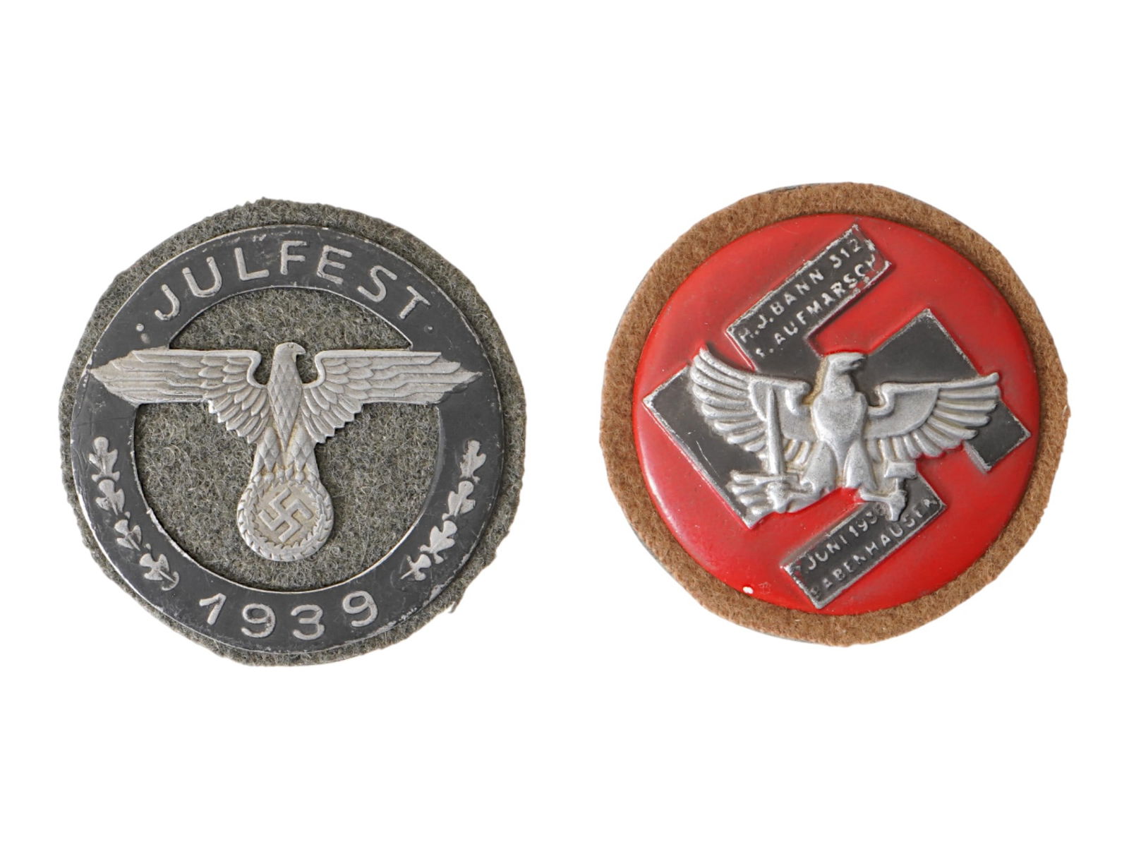 GROUP OF GERMAN WWII MODEL 1939 JULFEST HJ SHIELDS: A group of two Nazi German WWII model shields. The lot includes a 1939 Julfest featuring a Nazi eagle clutching a swastika insignia; and a commemorative badge of the Hitler Youth HJ organization. This