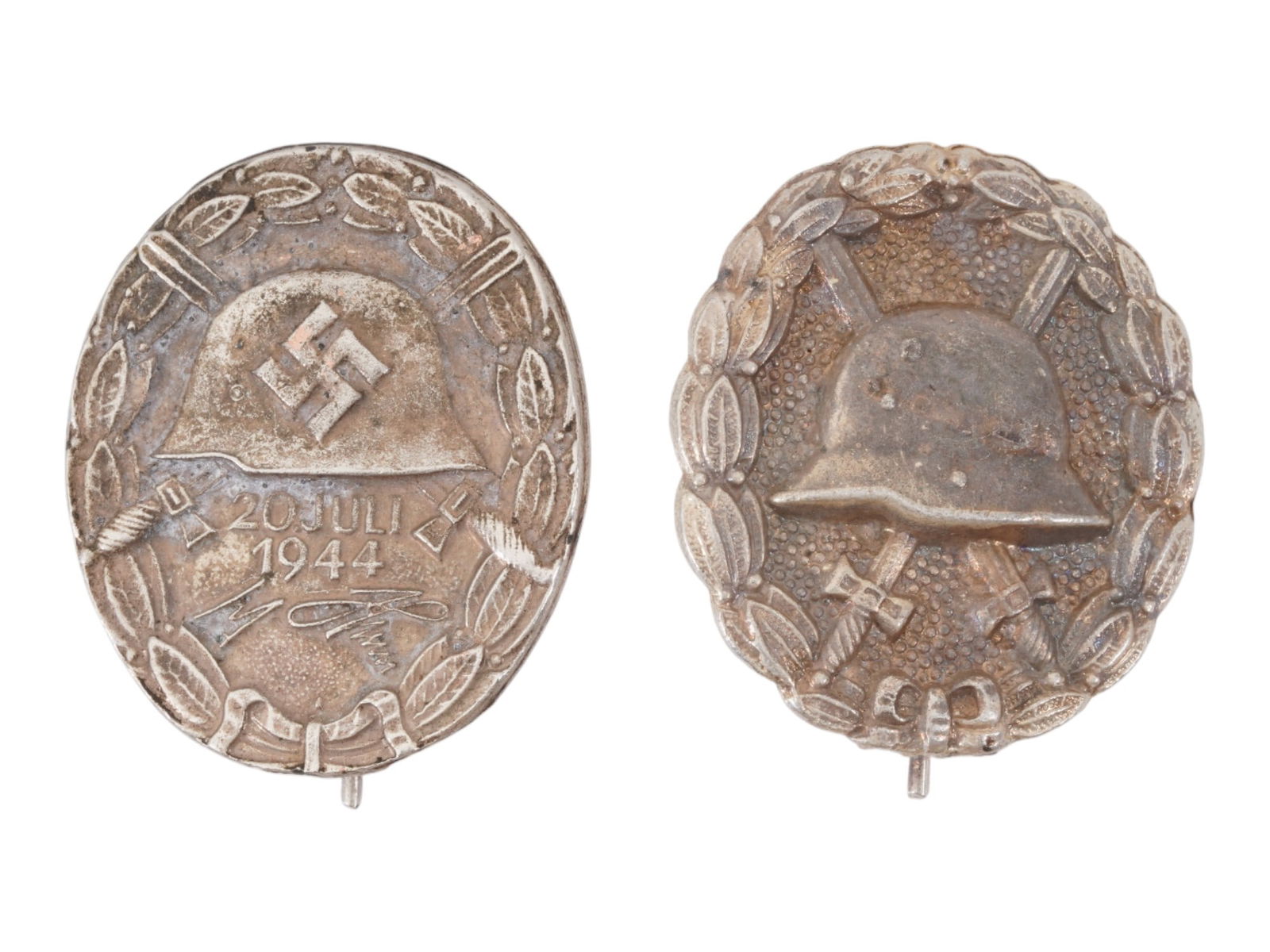 GROUP OF TWO WWII NAZI GERMAN WOUND BADGES: A group of two WWII Nazi German Wound Badges, consisting of a July 20, 1944 Wound Badge and a Wound badge. The July 20, 1944 badge commemorates those wounded during the assassination attempt on Adolf