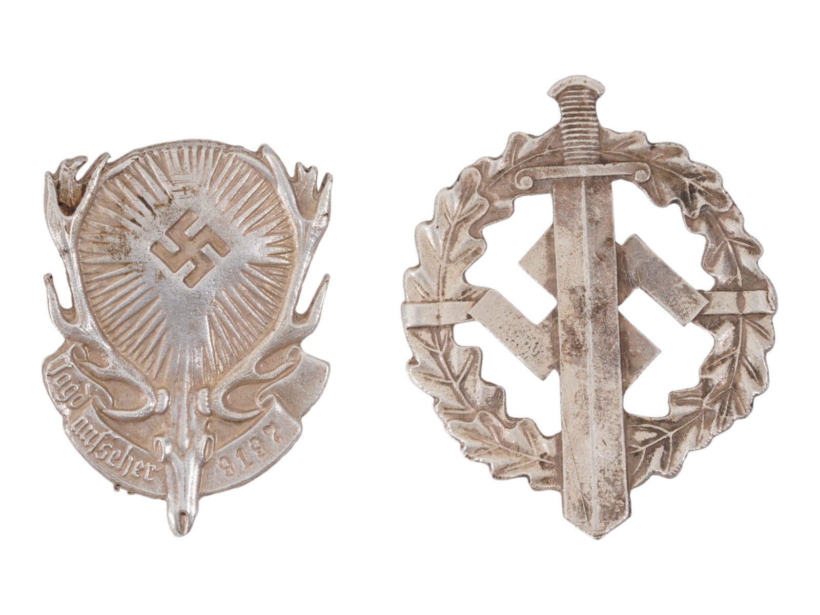 GROUP OF TWO WWII NAZI GERMAN BADGES SA SPORTS AWARD: A group of two WWII Nazi German badges, consisting of an SA Sports Award badge and a Third Reich Hunting Society badge. The SA Sports Award badge is typically oval in form, displaying a central sword