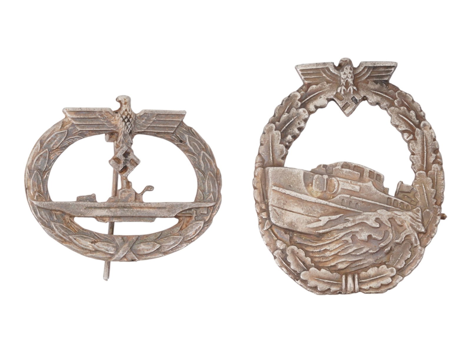 GROUP OF TWO WWII MODEL GERMAN MILITARY BADGES: A lot of two WWII model Nazi German Kriegsmarine decorations. U-Boat. E-Boat, first pattern, marked Schwerin Berlin 68 on the backside. World War II Historical Collectibles And Memorabilia, Military U
