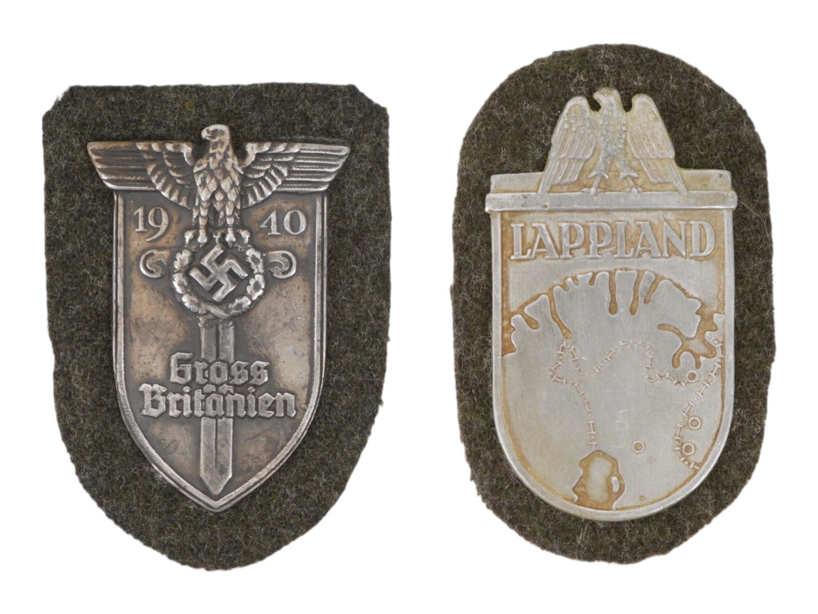 GROUP OF TWO WWII MODEL GERMAN SHIELDS: A pair of World War II type Nazi German military decorations. Lappland Shield. Grossbritanien Shield. Second World War Historical Collectibles And Memorabilia, Military Uniform Accessories, Insignia,