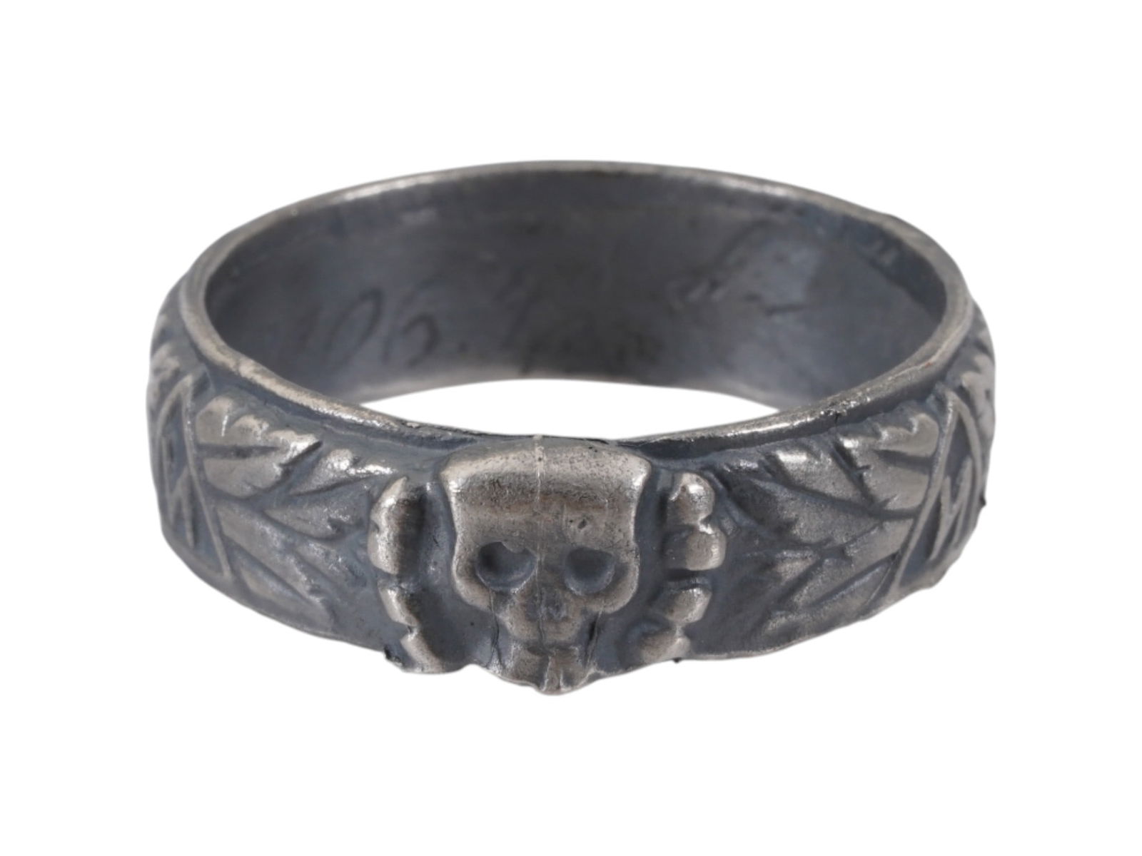 WWII MODEL NAZI GERMAN SS HONOR SILVER RING: A WWII model Nazi German Third Reich SS Himmler Honor silver ring. The exterior of the ring is engraved with oak leaves and swastika insignia patterns, and a Totenkopf insignia in the center. The inte