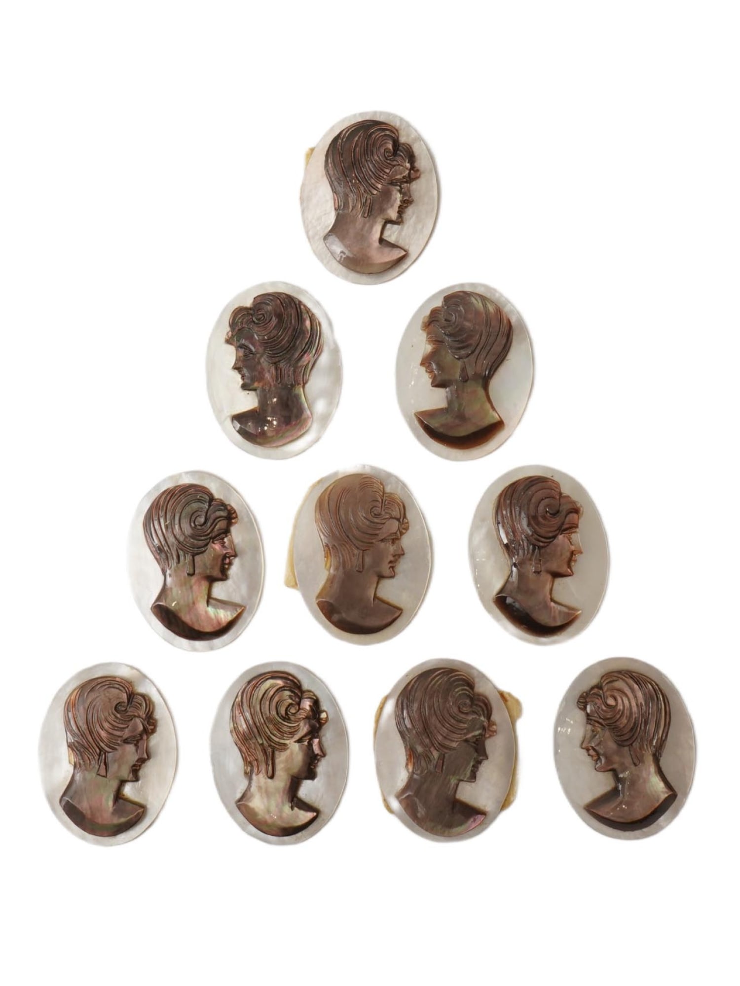 COLLECTION OF FEMALE PORTRAIT CARVED SHELL CAMEOS: A collection of hand carved conch chell cameos. A total of 10 items. Each piece is crafted from conch shell, featuring female profile portraits rendered in high relief. Oval shape. Collectible Jewelry
