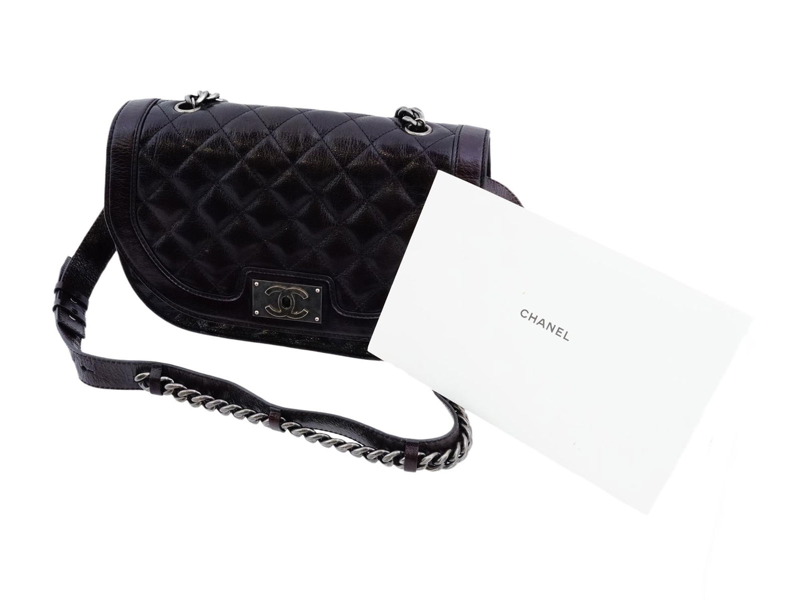 CHANEL DOUBLE CHAINED SADDLE MESSENGER BAG IN BLACK: A Chanel Double Chained Saddle Messenger Bag crafted from leather in black, accented with aged silver-tone hardware. Designed in the distinctive saddle-bag silhouette. Features a front flap with the i