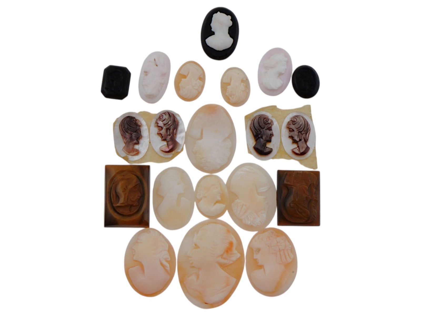 COLLECTION OF 20 ANTIQUE HAND CARVED CAMEOS: A collection of 20 antique Neoclassical cameos hand carved of semi precious stones and conch shells. Oval and rectangular shaped cameos. Some pieces feature double portraits of warriors, some feature