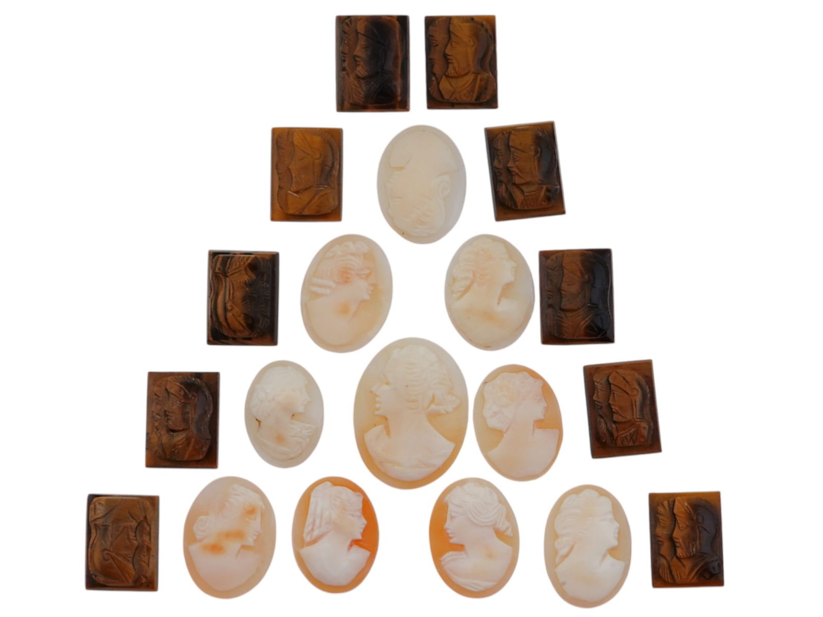 COLLECTION OF ANTIQUE HAND CARVED STONE CAMEOS: A collection of antique Neoclassical cameos hand carved of semi precious stones. Some pieces feature double portraits of warriors, some feature female portraits. Oval and rectangular shaped. Dating ba