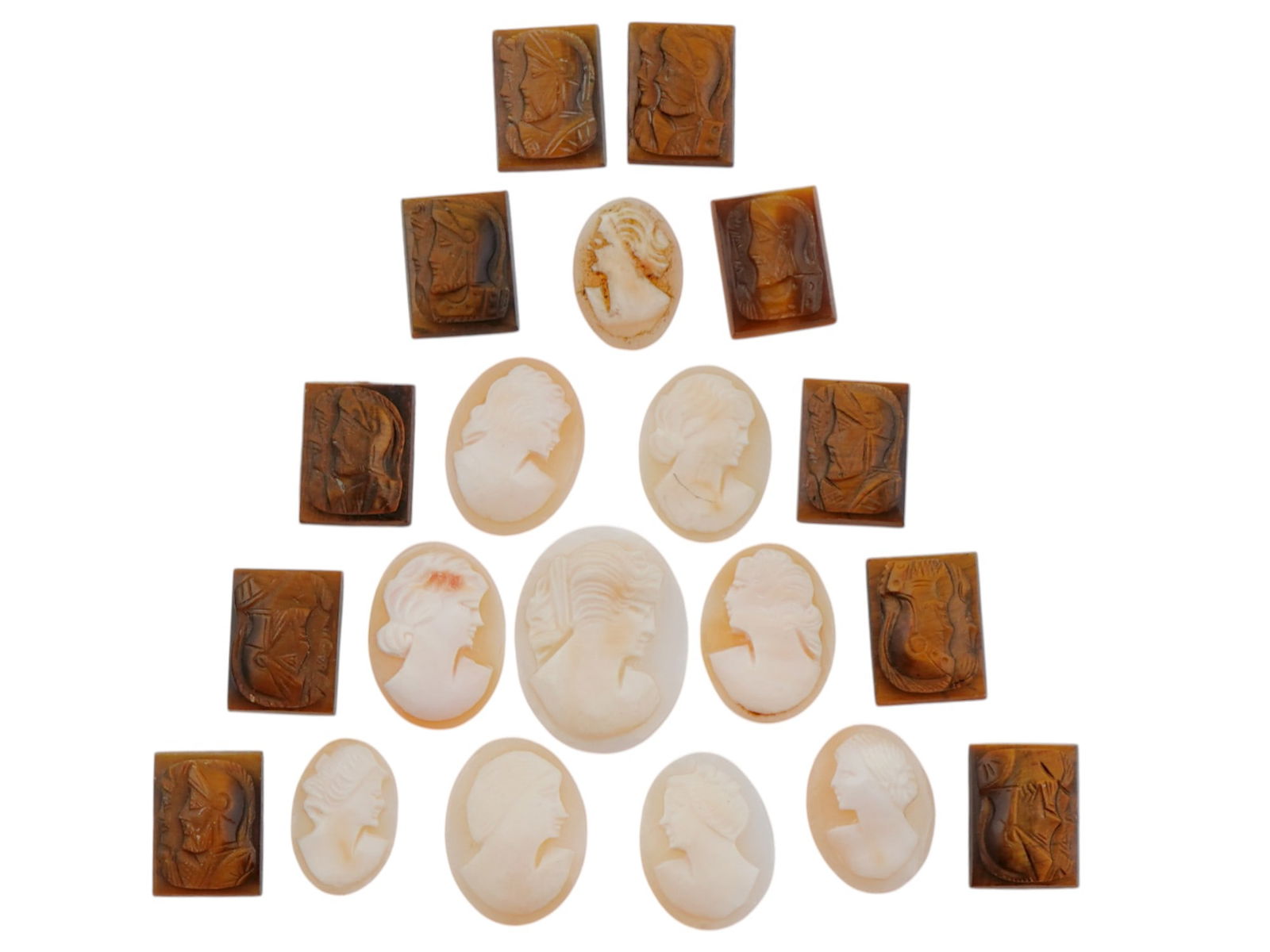 COLLECTION OF ANTIQUE HAND CARVED CAMEOS: A large collection of antique Neoclassical hand carved cameos. Some pieces feature double portraits of warriors, and some feature female portraits. Oval and rectangular shaped. Dating back to the late