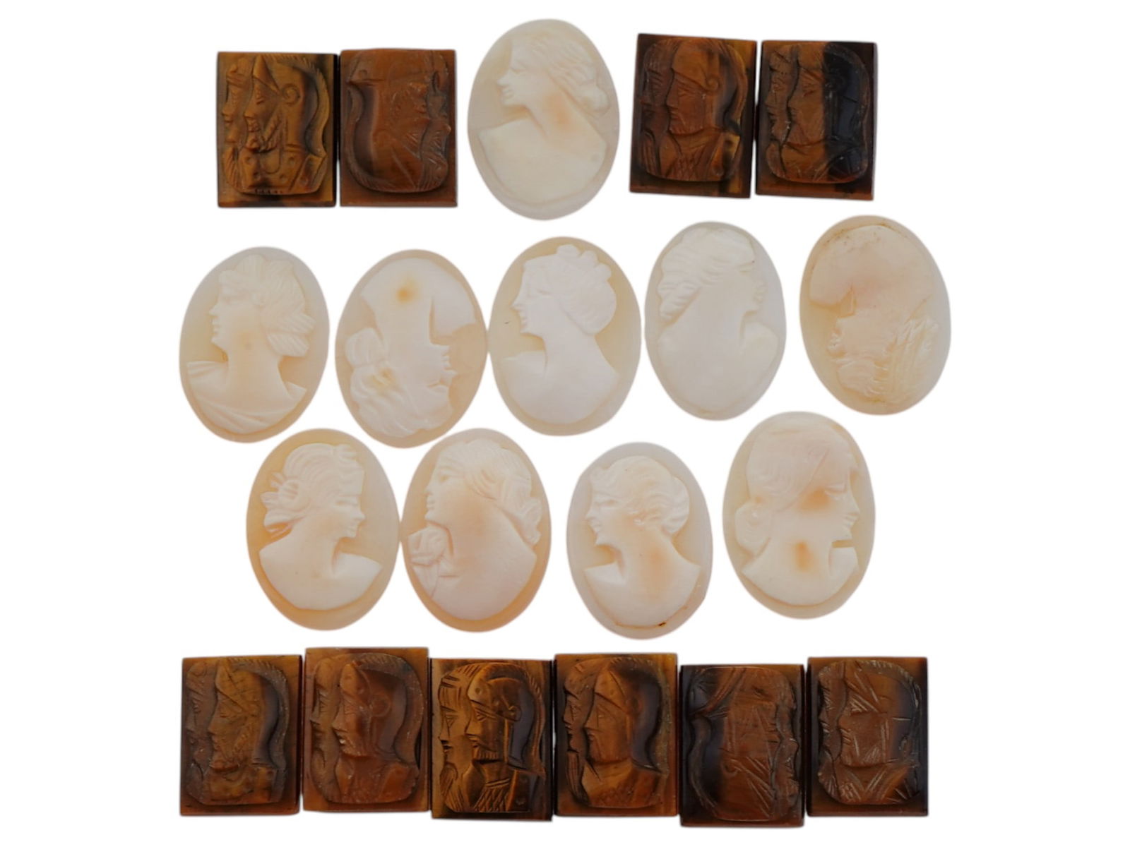 COLLECTION OF VARIOUS ANTIQUE HAND CARVED CAMEOS: A collection of antique hand carved cameos, dating to the late 19th to early 20th century. Each piece features classical female portraits or knights in armor rendered in high relief. The cameos are pr