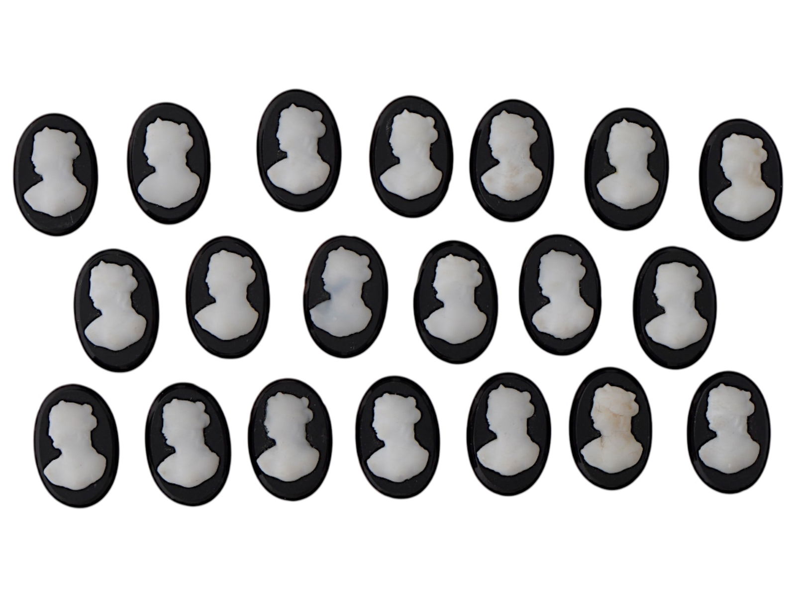COLLECTION OF FEMALE PORTRAIT ONYX SHELL CAMEOS: A large collection of vintage oval shaped cameos. Each cameo with an oval cut onyx panel with applied carved shell depicting a portrait of a lady in profile. Victorian Manner Jewelry And Accessories,