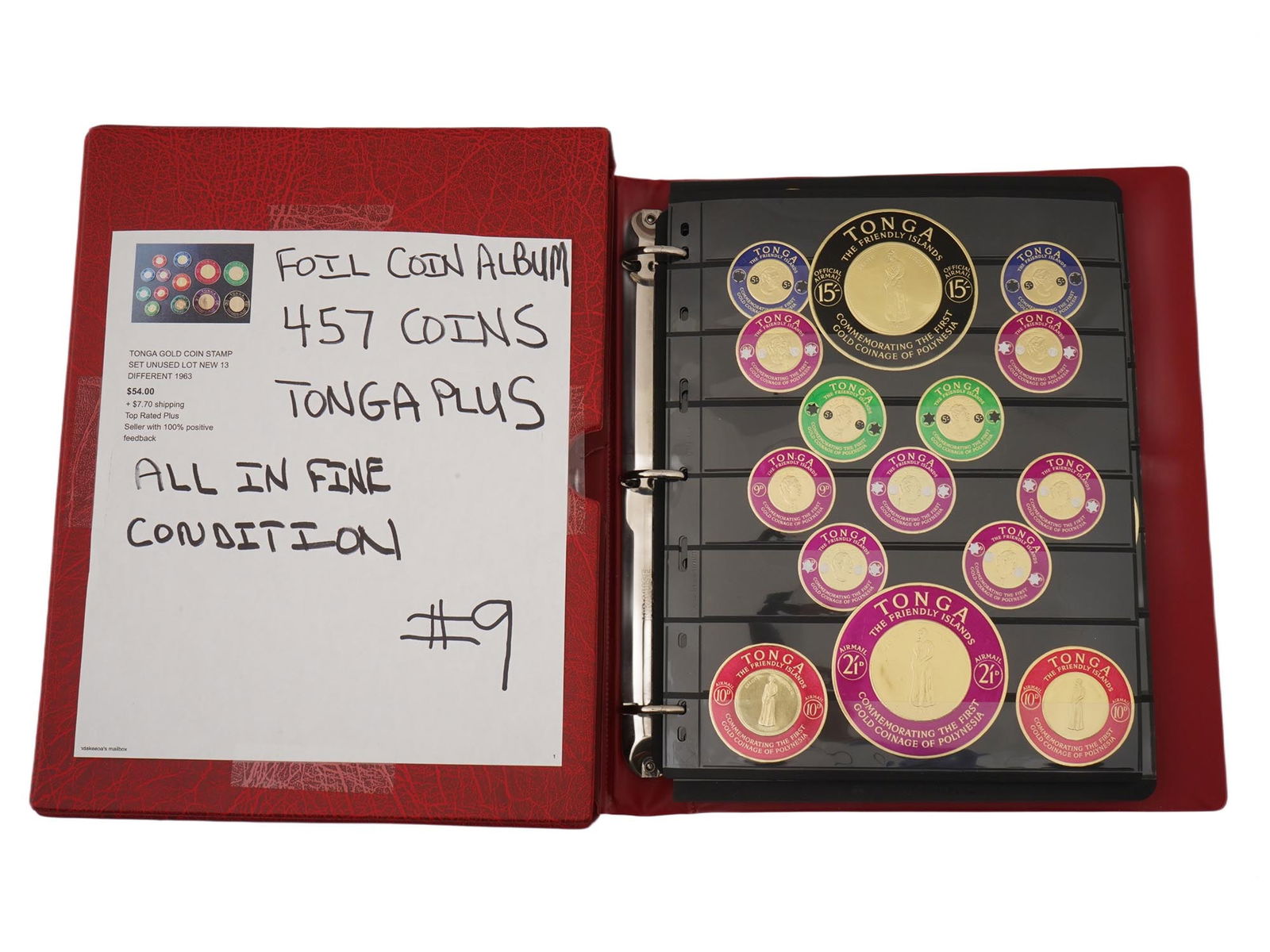 LOT OF 457 TONGA FOIL COINS POSTAGE STAMPS IN ALBUM: A collection of 457 Tongan postage stamps that imitate gold coins issued in the 1960s. These unique round stamps, often made of gold foil, were issued in 1963 to commemorate the first gold coinage in