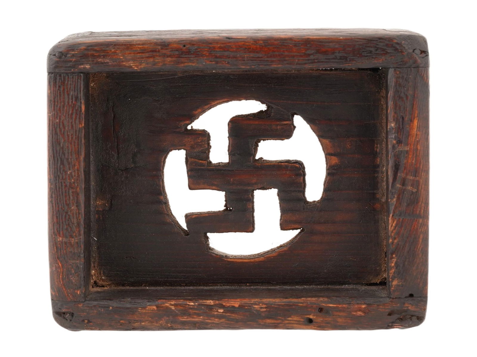 KOREAN MANJA PAULOWNIA ODONG NAMU WOOD PILLOW: A rare Korean Odong Namu, or Paulownia wood, pillow with a Manja symbol. The rectangular pillow with an openwork Buddhist symbol in the center. Manja is the Korean name for the Buddhist swastika, a sy