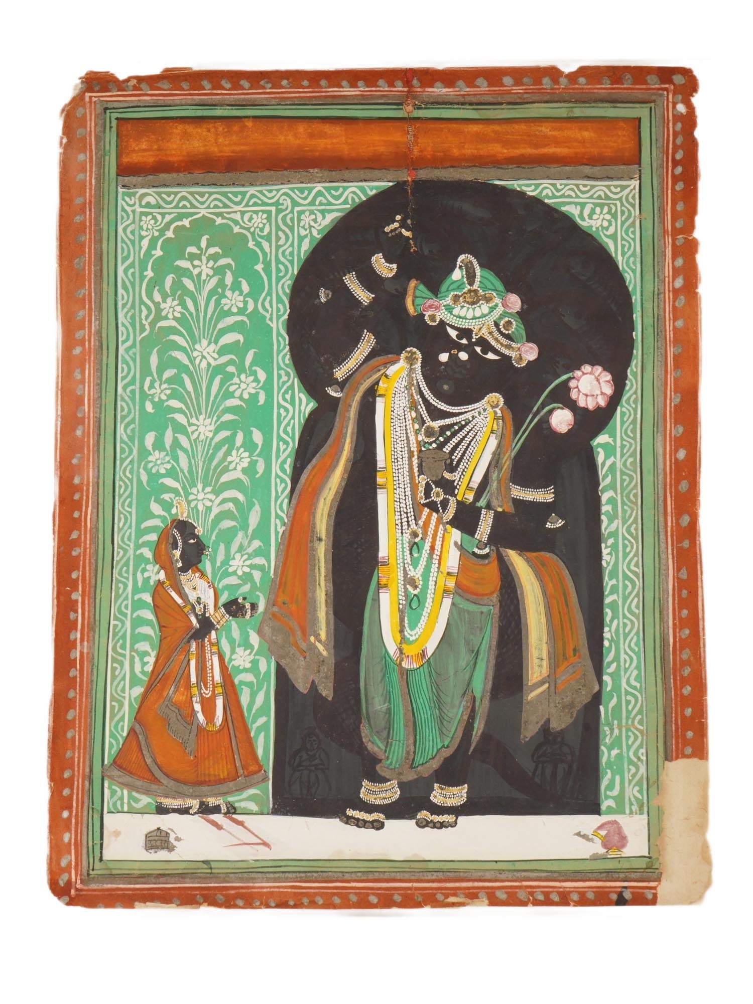 ANTIQUE INDIAN MUGHAL MINIATURE PAINTING SHRINATHJI: An antique Indian Mughal–period miniature painting, depicting Shrinathji, a revered manifestation of Lord Krishna portrayed as a divine child. The composition shows the deity with a dark complexion,