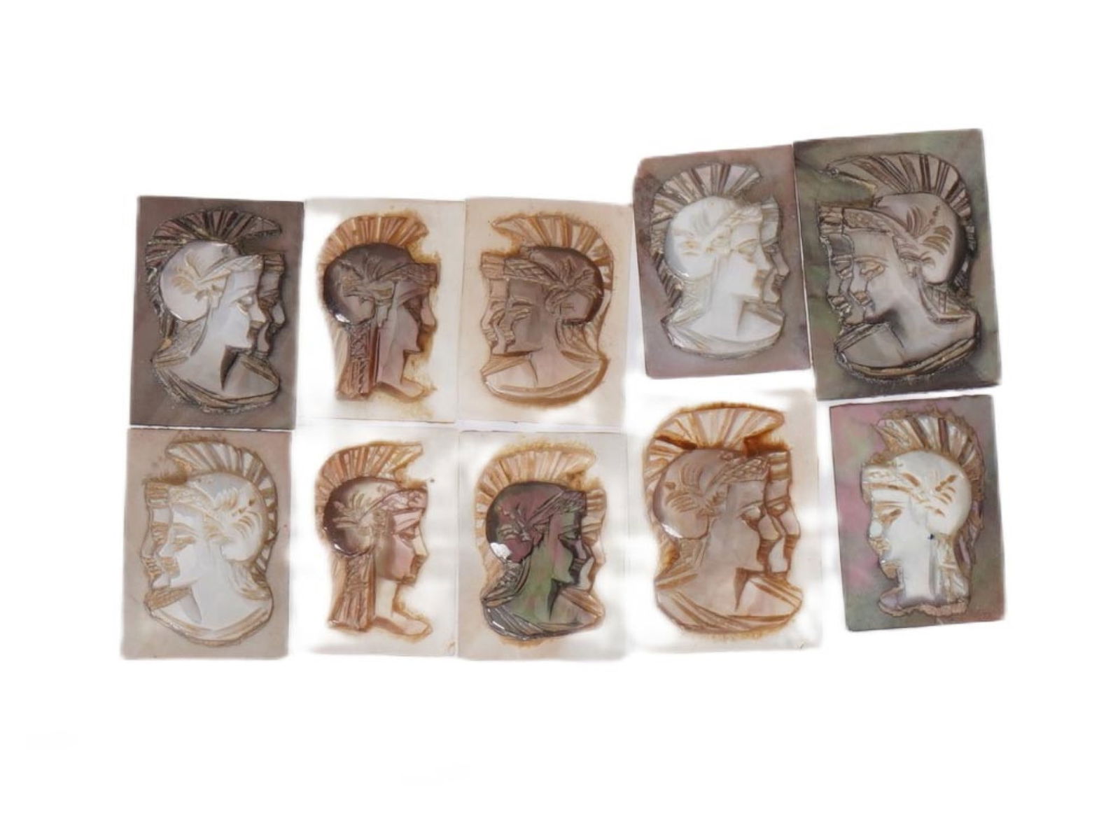 COLLECTION OF PORTRAIT CARVED SHELL CAMEOS: A collection of hand carved conch shell cameos. A total of 10 items. Each piece features double knight profile portraits rendered in high relief. Square shape. Collectible Jewelry And Glyptic Art, Scu
