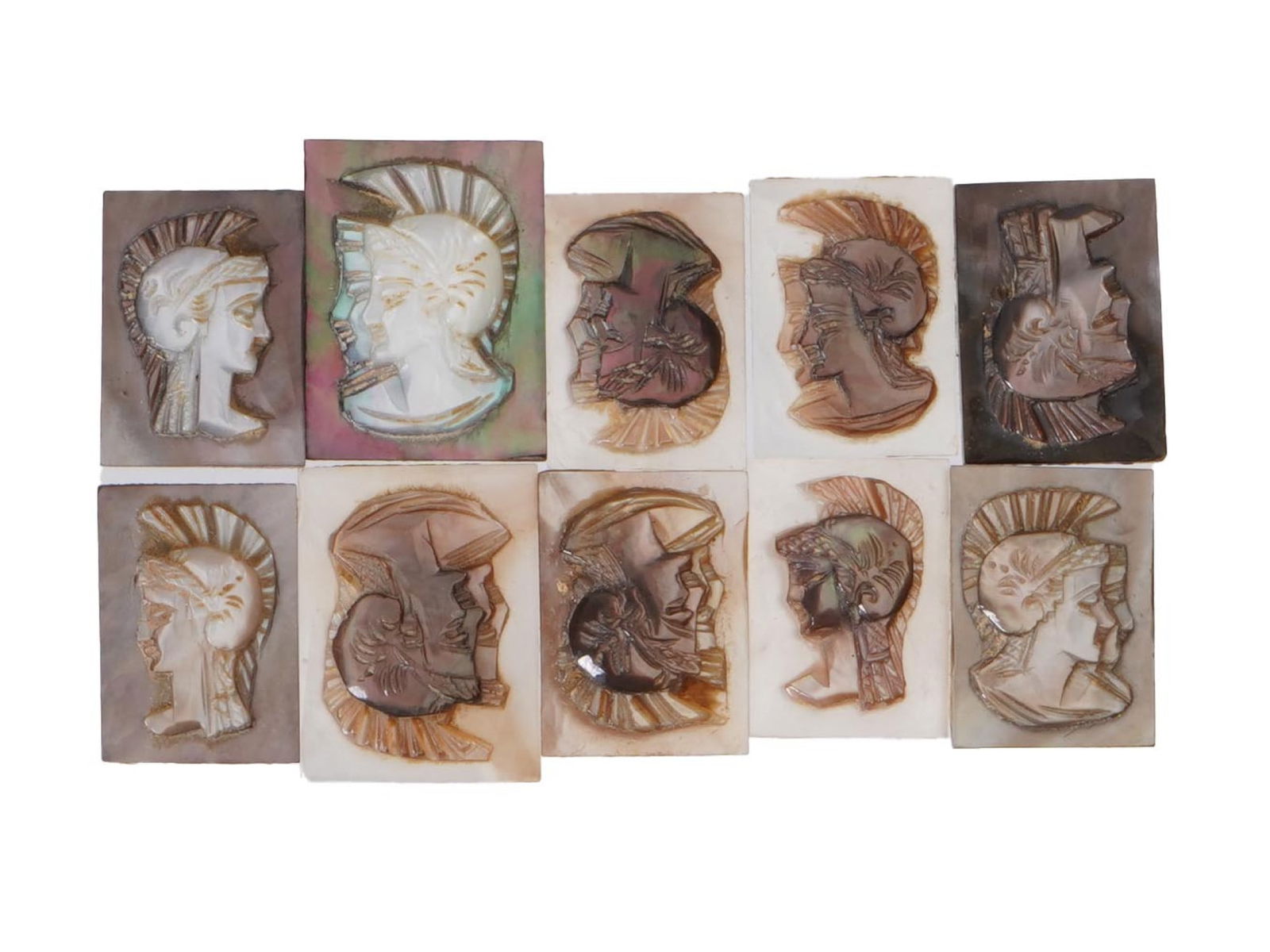 COLLECTION OF PORTRAIT CARVED SHELL CAMEOS: A collection of hand carved conch shell cameos. A total of 10 items. Each piece features double knight profile portraits rendered in high relief. Square shape. Collectible Jewelry And Glyptic Art, Scu