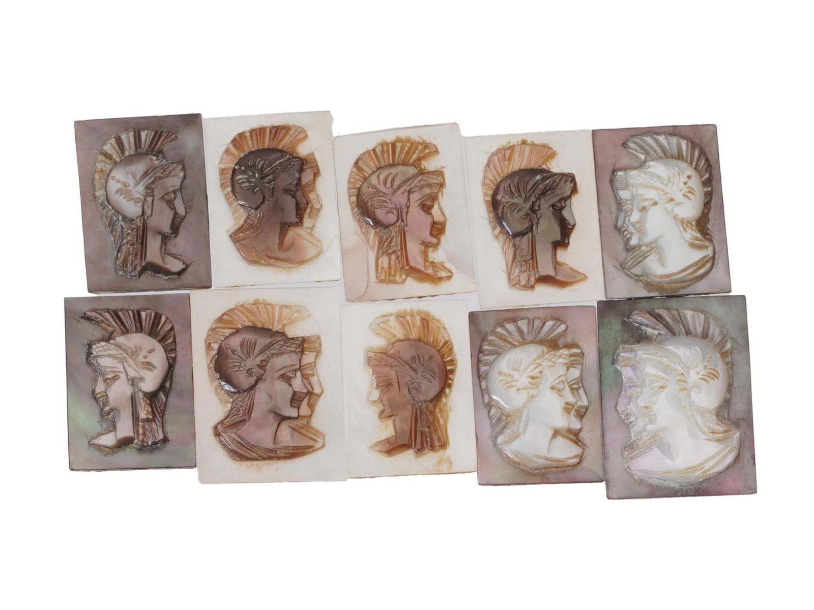 ANTIQUE VINTAGE GRECO ROMAN PROFILE CARVED SHELL CAMEOS: A set of ten antique or vintage carved shell cameos, each depicting the head profile of a Greco-Roman figure wearing a crested helmet. Carved from a mother of pearl or abalone shell, the pieces displa