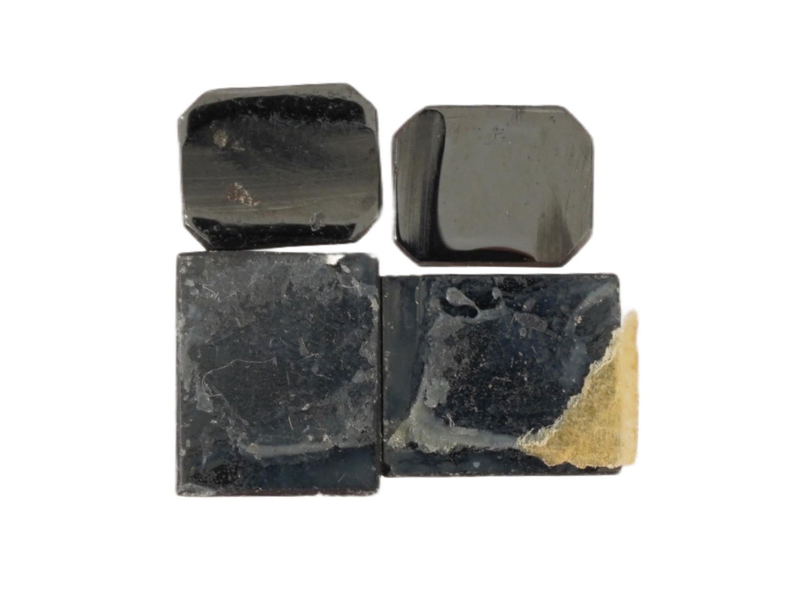 COLLECTION OF CARVED HEMATITE INTAGLIOS ROMAN SOLDIERS: A collection of carved hematite intaglios featuring profiles of Roman soldiers, intended as vintage mens jewelry accents for rings or cufflinks. Crafted from hematite, a dark metallic stone, the desig