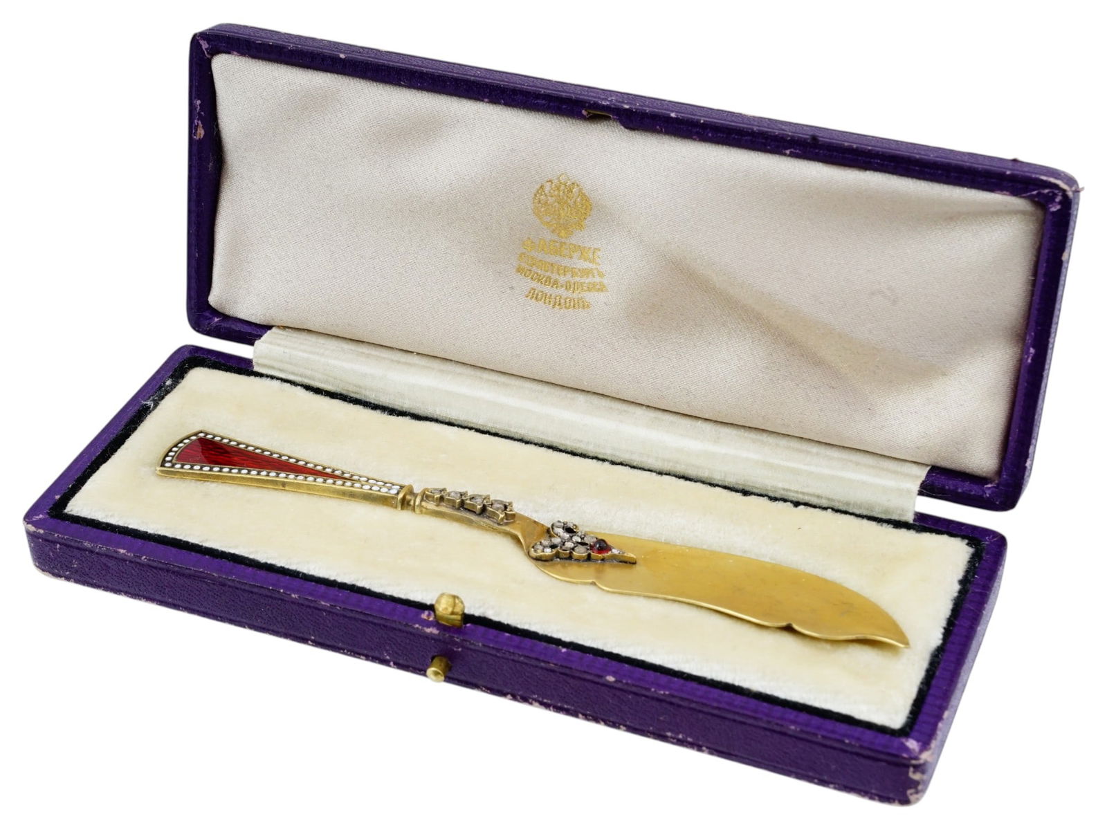 RUSSIAN SILVER ENAMEL DIAMOND AND GARNET LETTER OPENER: A Russian gilt silver and enamel letter opener adorned with diamonds and a garnet. The tapered handle is decorated with red guilloche enamel and bordered by delicate white enamel dots. Accented with d