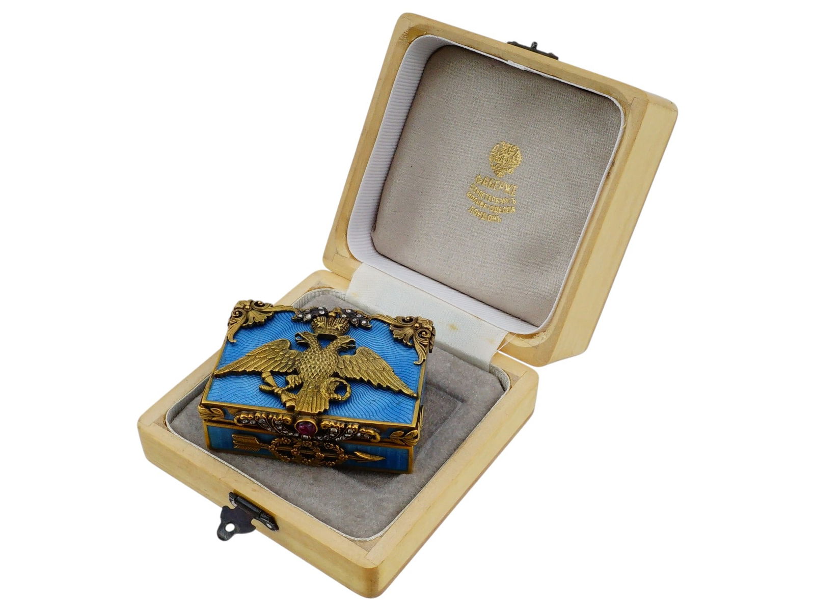 RUSSIAN GILT SILVER ENAMEL AND DIAMONDS PILL BOX: A Russian gilt silver pill box adorned with enamel and diamonds. The lid features a large, gilt silver Imperial Double-Headed Eagle, the traditional symbol of the Russian Empire. The box is decorated