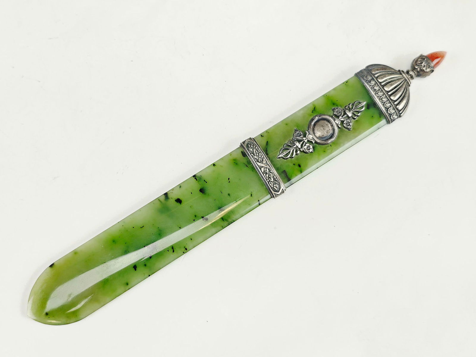 RUSSIAN SILVER NEPHRITE JADE PAPER KNIFE W CARNELIAN: A Russian Silver mounted carved Nephrite Jade paper or letter knife. The silver part is adorned with engraved cross, foliage and scrollwork motifs and a carnelian finial on the top. Hallmarked with an