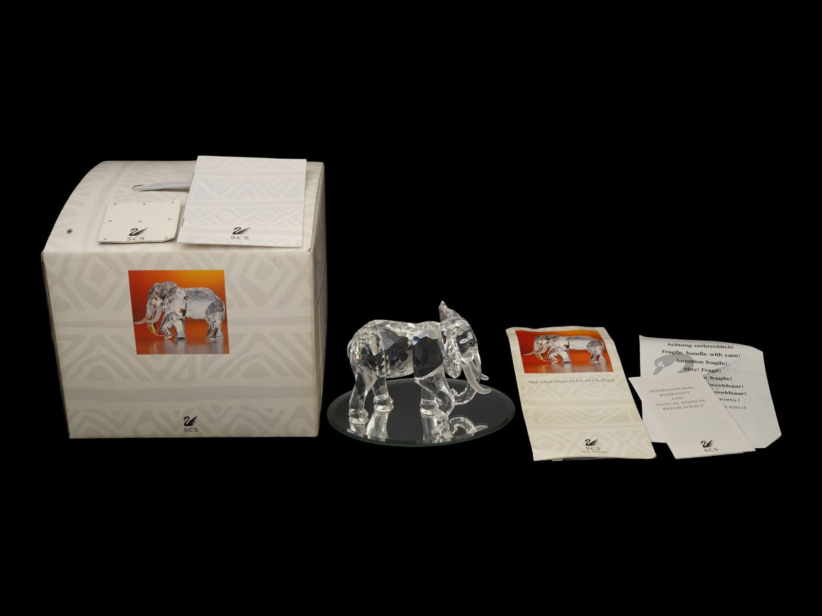 SWAROVSKI SCS CRYSTAL AFRICA ELEPHANT FIGURINE IOB: A Swarovski crystal elephant figurine, released in 1993 from the Inspiration Africa series. Annual Edition for Swarovski Collectors Club SCS members. Designed by Martin Zendron. Faceted clear crystal