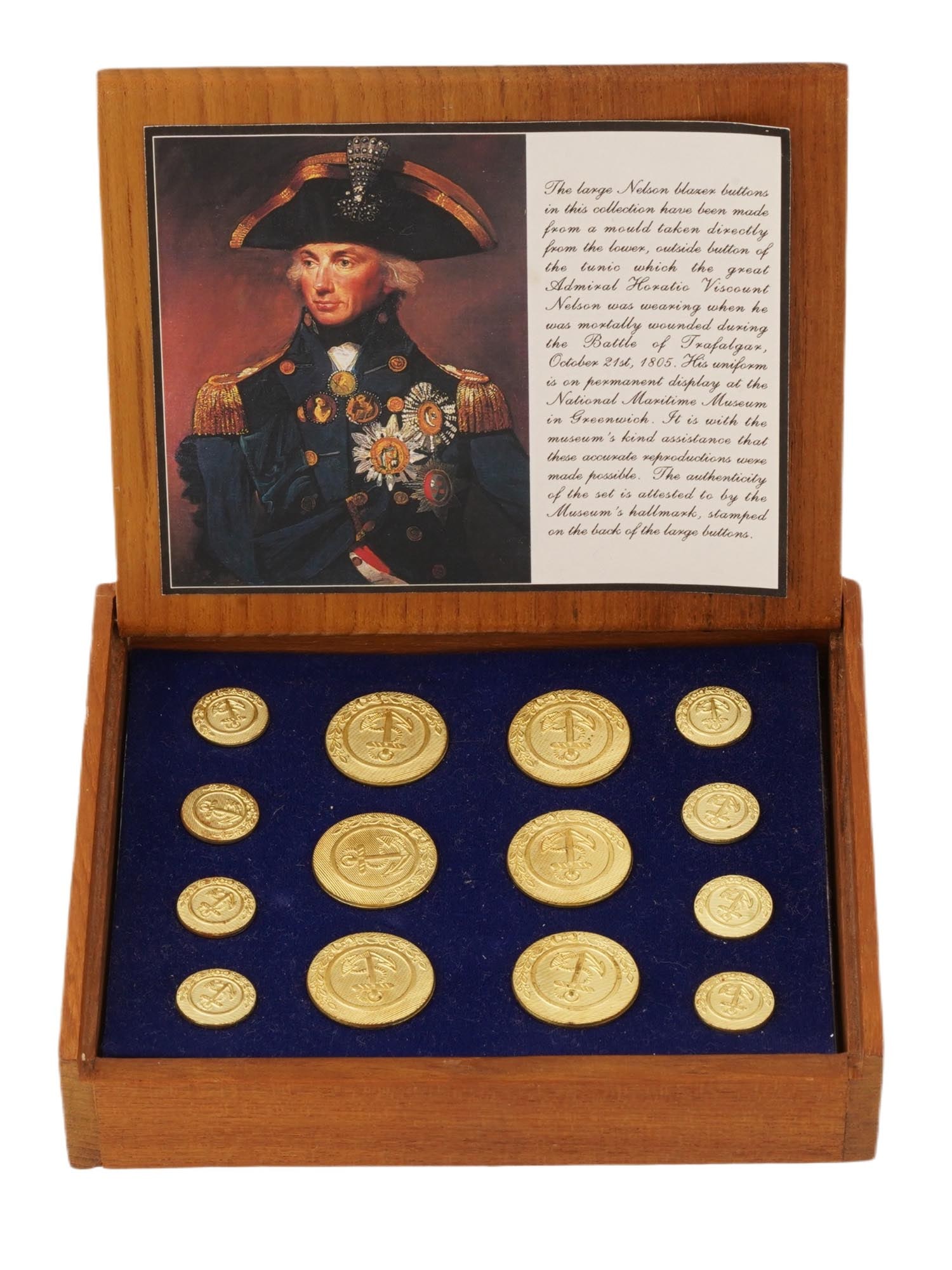 ADMIRAL NELSON SET NAVAL COMMEMORATIVE BUTTONS IN BOX: A commemorative set gilt naval buttons in a wooden presentation box, modeled after the original buttons on Vice-Admiral Horatio Nelsons Trafalgar uniform. The buttons feature an anchor motif, traditio