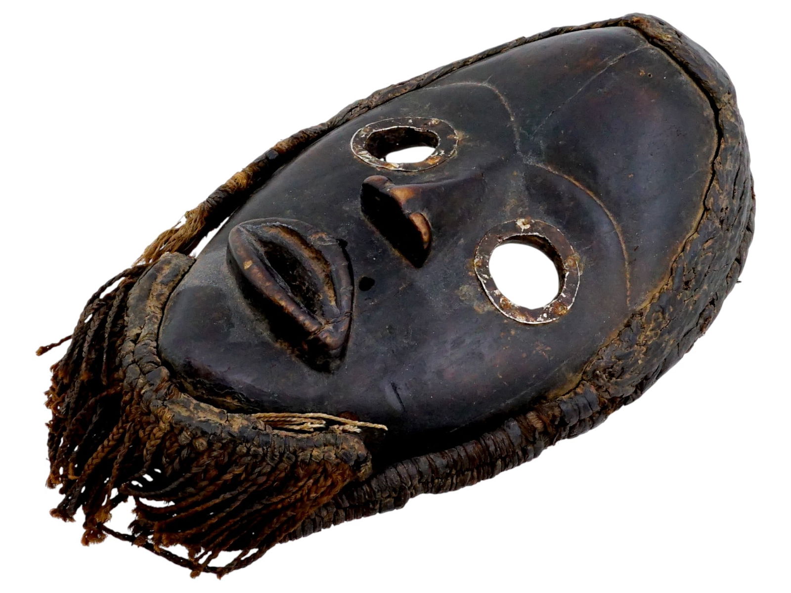 AFRICAN IVORY COAST HAND CARVED WOOD DEANGLE MASK: A 20th century hand carved wooden face mask from Ivory Coast. The oval face is depicted with a high forehead, an expanding nose, a protruding open mouth and wide round eyes. Dan people, Deangle mask w