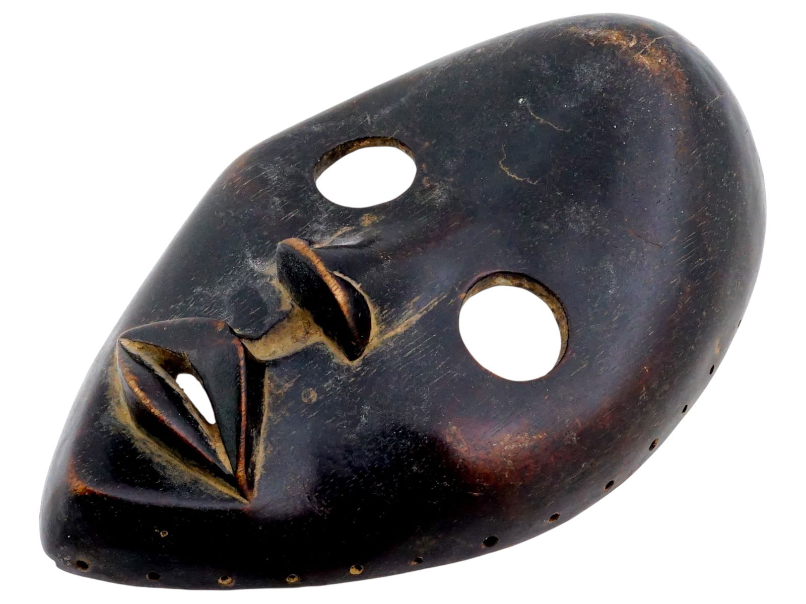 AFRICAN IVORY COAST MANDE DAN CARVED WOOD MASK: A traditional African hand carved wood tribal mask of the Dan people, a Mande ethnic group from northwestern Ivory Coast and neighboring Liberia. They are officially known as Yacouba in Ivory Coast. T