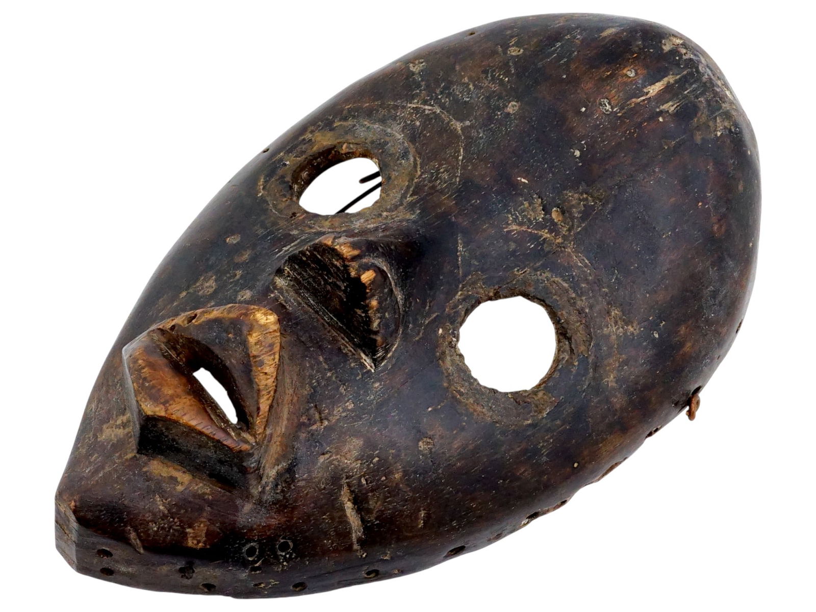 AFRICAN IVORY COAST MANDE DAN CARVED WOOD MASK: A traditional African hand carved wood tribal mask of the Dan people, a Mande ethnic group from northwestern Ivory Coast and neighboring Liberia. They are officially known as Yacouba in Ivory Coast. T