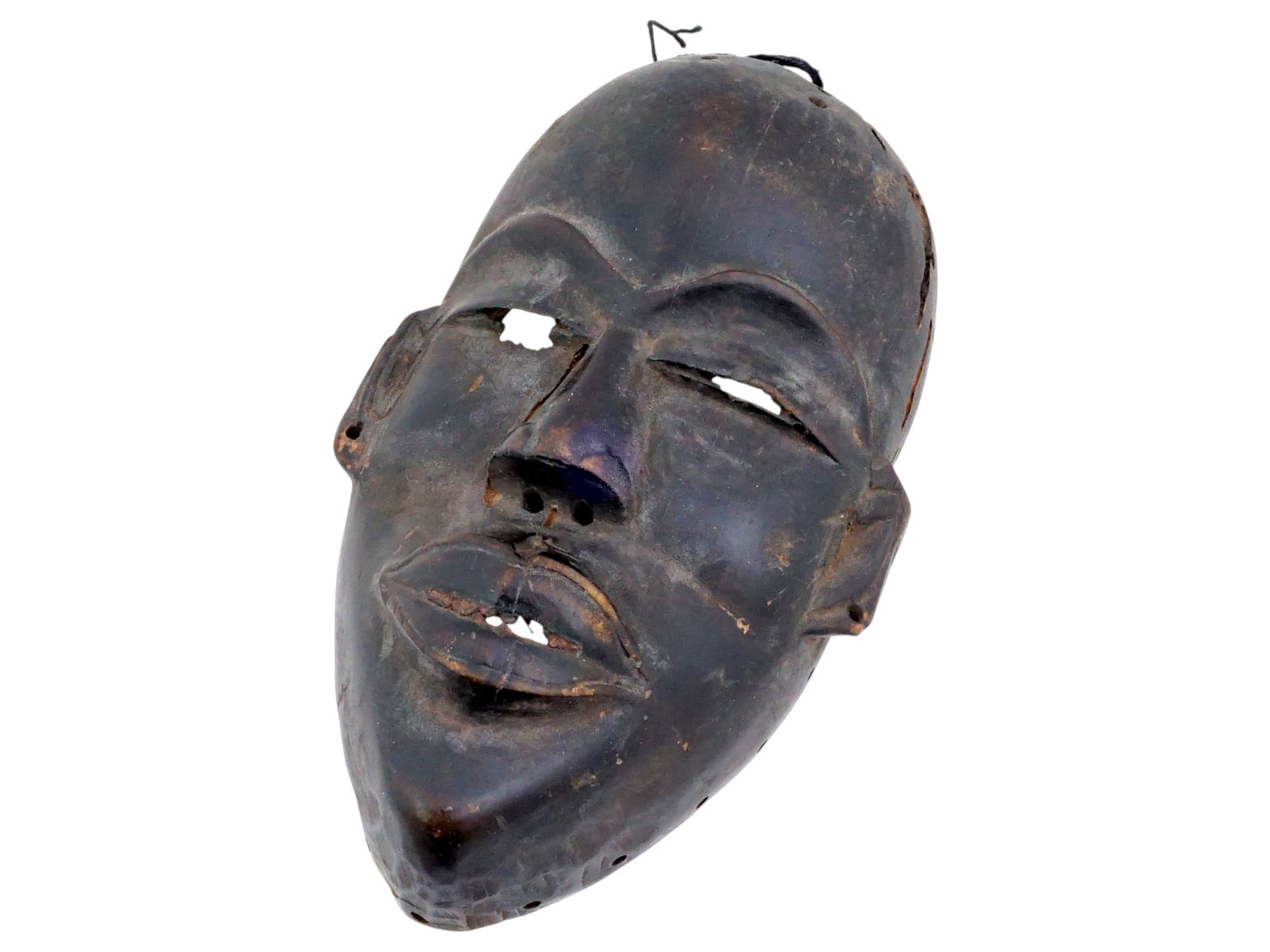 AFRICAN DAN PEOPLE MANDE CARVED WOOD TRIBAL MASK: A traditional African hand carved wood tribal mask of the Dan people, a Mande ethnic group from northwestern Ivory Coast and neighboring Liberia. They are officially known as Yacouba in Ivory Coast. T