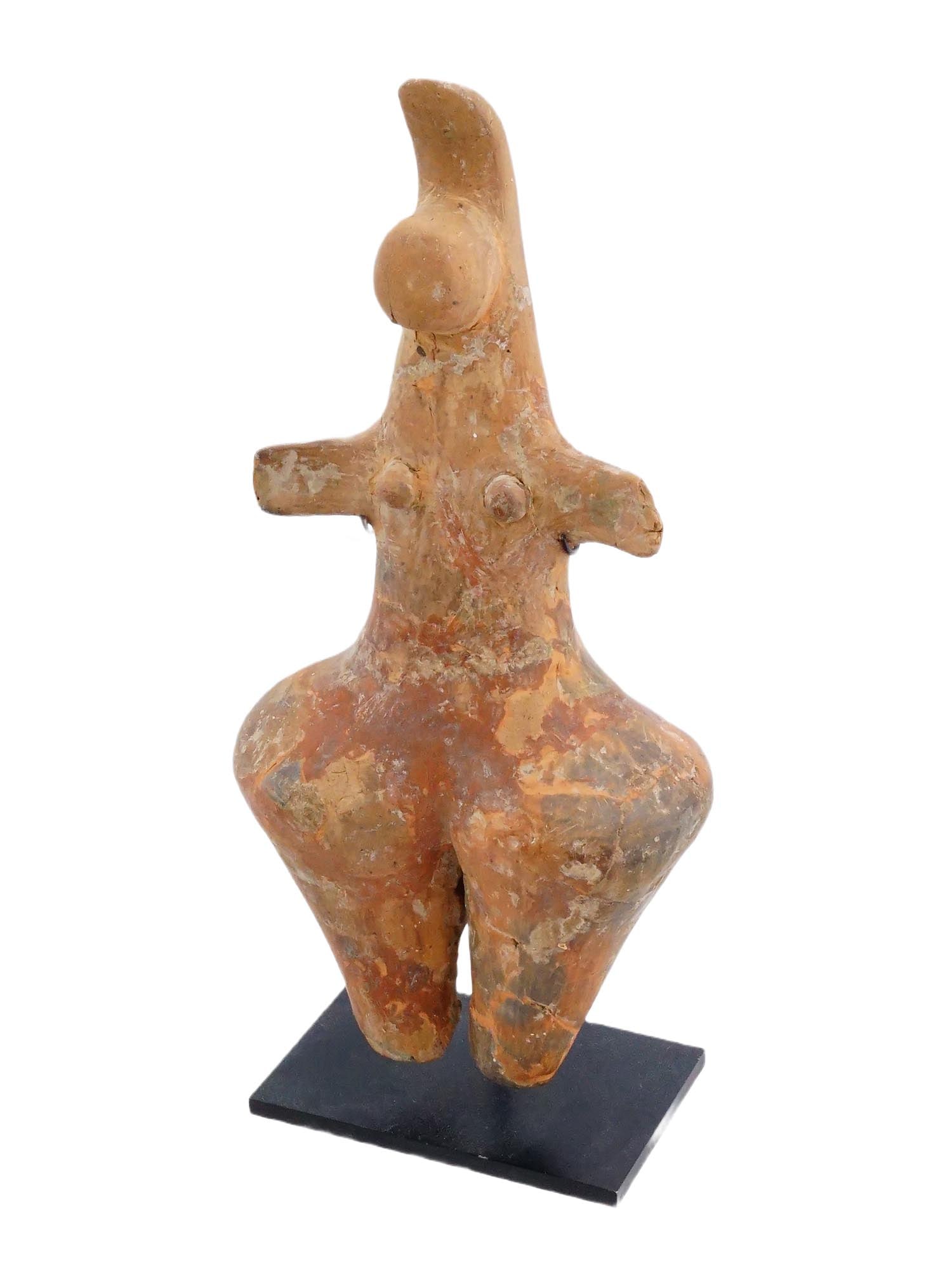 ANCIENT TERRACOTTA FEMALE IDOL ON STAND CA 3000 BC: An ancient terracotta female idol, presumably from the Amlash culture, which flourished in the Gilan province of northern Iran. Circa 3000 BC. The figure is characterized by its steatopygous form, mea