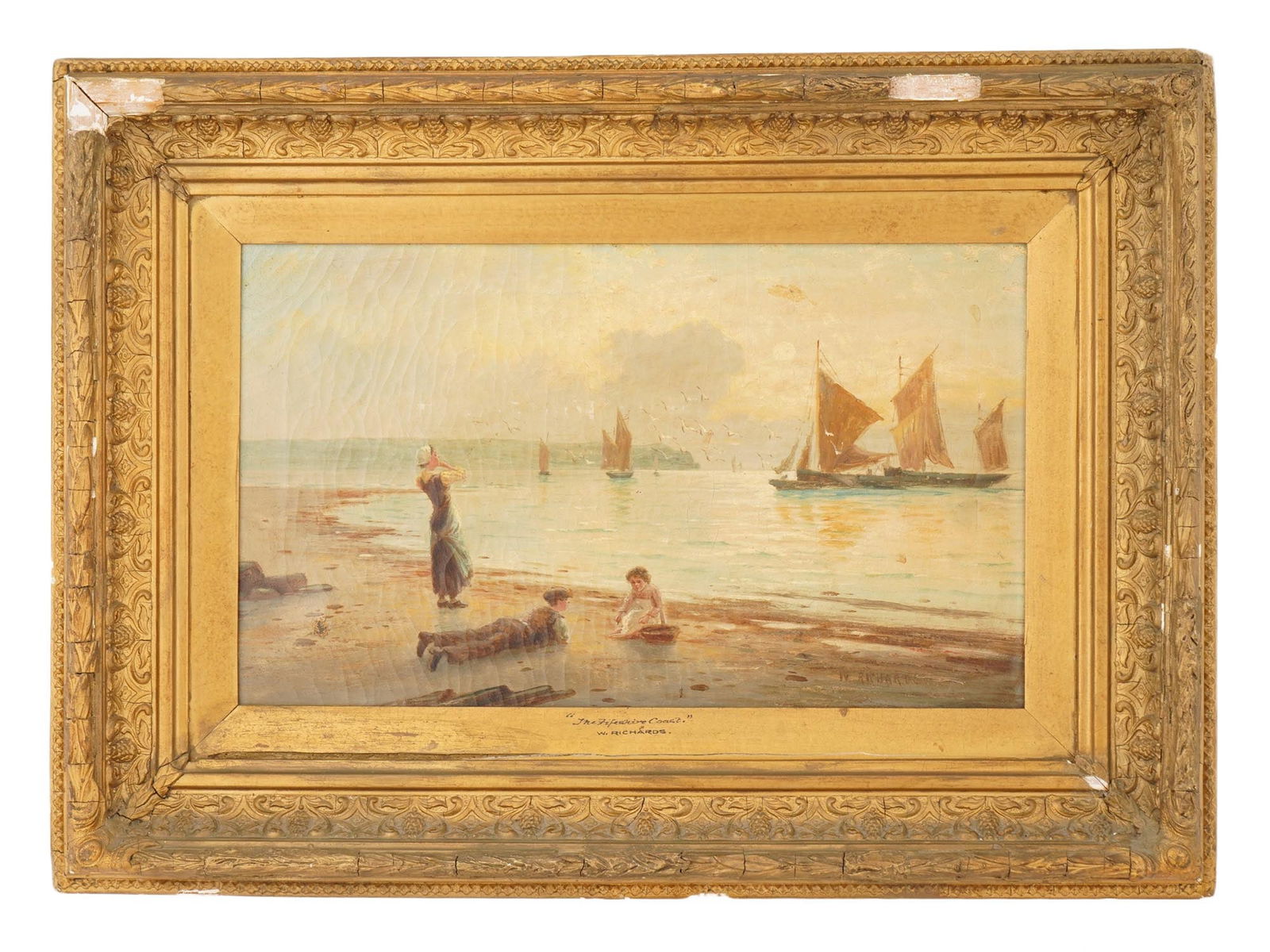 SEASCAPE PAINTING SIGNED W. RICHARDS FIFESHIRE COAST: An antique oil seascape painting on canvas titled Fifeshire Coast and signed W. Richards lower right, depicting a tranquil coastal view with children playing at the shoreline and sailing boats in the
