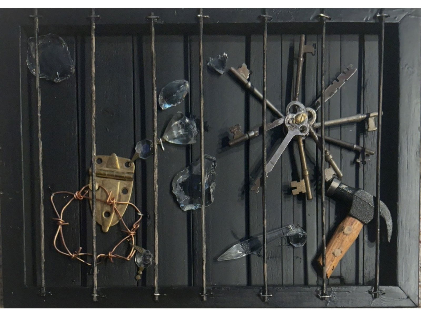 MANNER OF LOUISE NEVELSON KRISTALLNACHT ASSEMBLAGE 1970: Mixed media shadow box assemblage titled Kristallnacht, constructed from black painted wood and found objects including skeleton keys arranged in a starburst, a hammer, metal hardware, copper wire, an