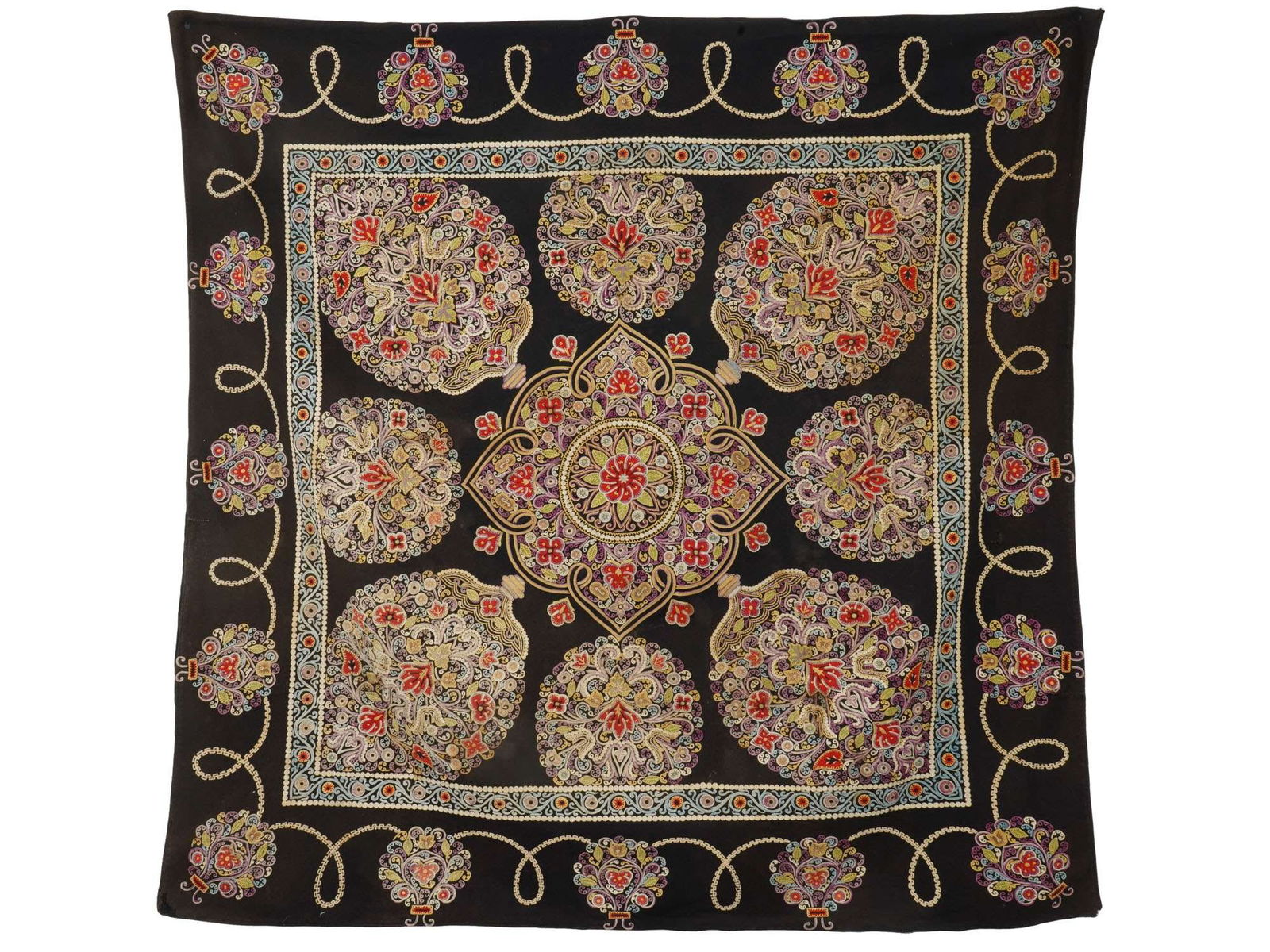 ANTIQUE 19TH C PERSIAN RASHT WORK TEXTILE PANEL: An antique Persian Rachti douzi textile panel skilfully hand embroidered with traditional stylized floral motifs in rich colored silk on a dark brown linen ground. Dated from the late 19th century. Or