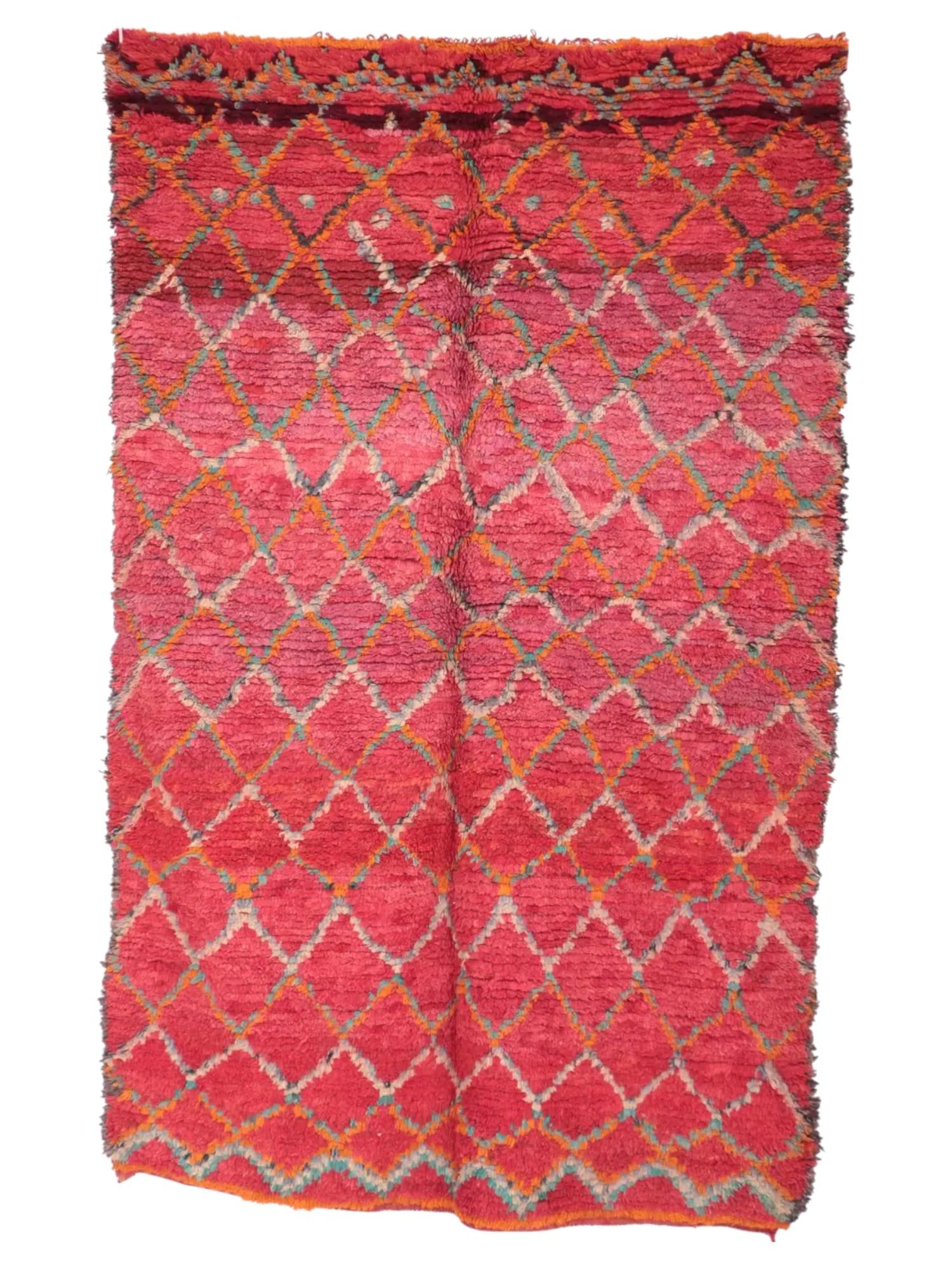 VINTAGE MOROCCAN BOUJAD RED PATTERNED RUG: A vintage Moroccan Boujad rug, dominated by shades of red. The rug features a diamond pattern throughout its field, outlined in a lighter color. The rug has a shaggy pile, characteristic of Boujad rug
