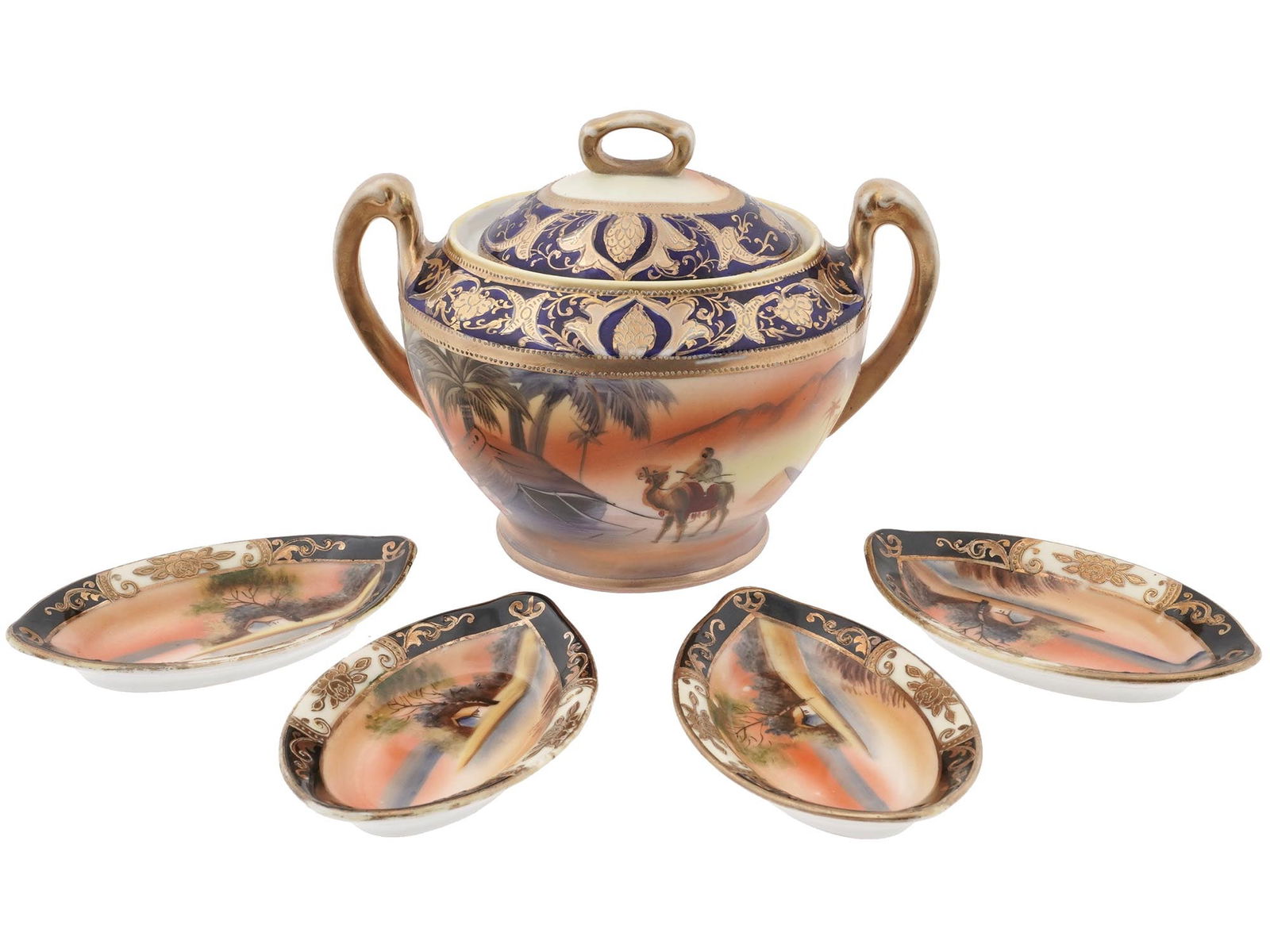 NORITAKE JAPAN PORCELAIN SUGAR VASE AND PLATES: The lot includes a fine Japanese porcelain lidded sugar vase with bright cobalt blue and gold highlights, the body is hand painted with a scene depicting a desert and a man riding on a camel. And four