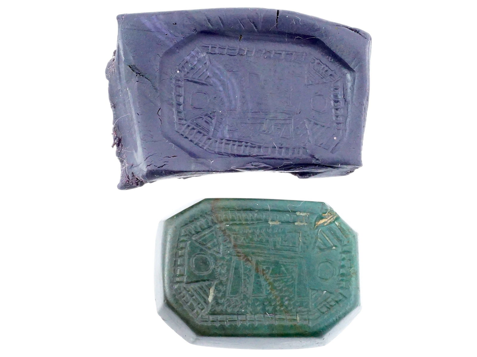 HAND CARVED GREEN JASPER STONE INTAGLIO SEAL AMULET: A hand carved green Jasper stone intaglio seal amulet. The octagonal shaped amulet is adorned with ornaments and symbols. Seals were generally used to mark ownership, and they could act as official id