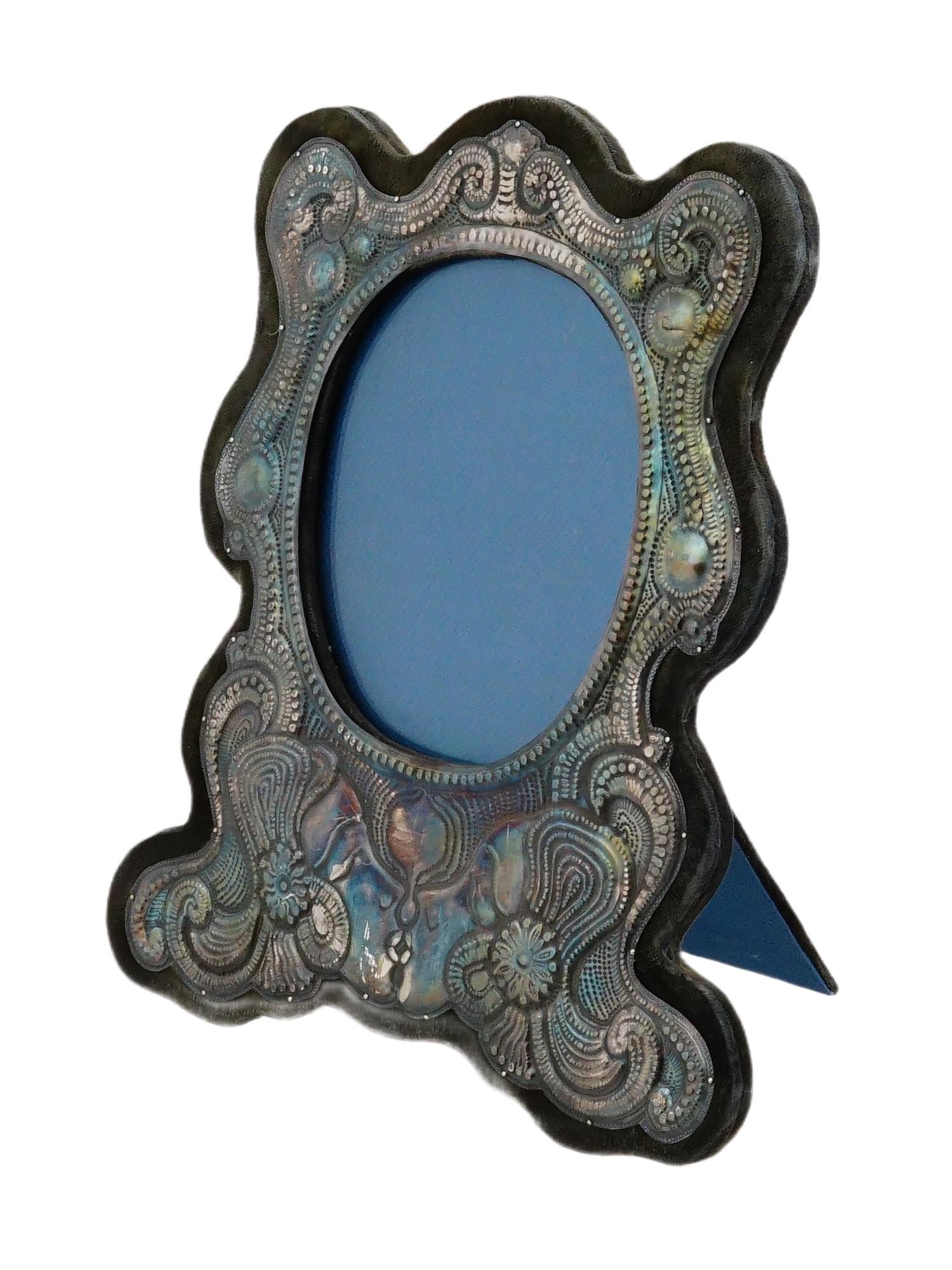 ANTIQUE ART NOUVEAU SILVER PALTED PICTURE FRAME: An antique Art Nouveau silver-plated picture frame, decorated with flowing organic lines and floral motifs characteristic of the late 19th to early 20th century design movement. With fabric-covered