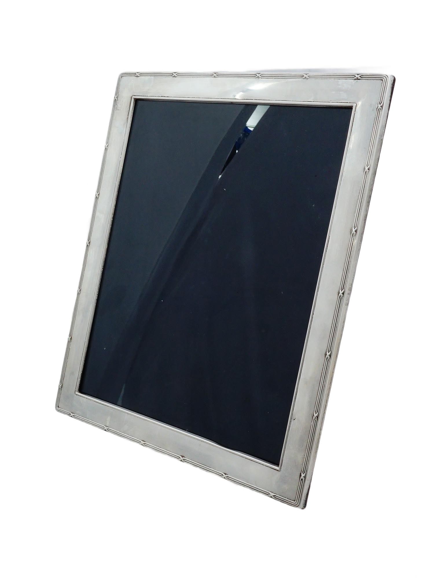 ENGLISH CARRS SILVER SHEFFIELD STERLING PHOTO FRAME: A vintage Carrs Silver rectangular shaped sterling silver photo frame. The frame is adorned with rounded corners and a decorative border featuring a cross pattern. Manufactured in England and bears Br