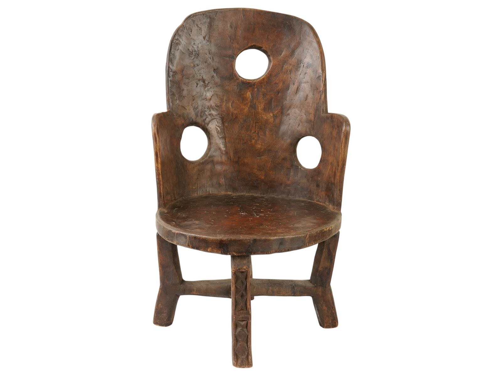 AFRICAN TANZANIAN MAKONDE HAND CARVED WOODEN CHAIR: An African Makonde hand carved wooden chair, a remarkable example of hand-carved furniture from the Makonde people of southeast Tanzania and northern Mozambique. The chair features a bold, minimalist
