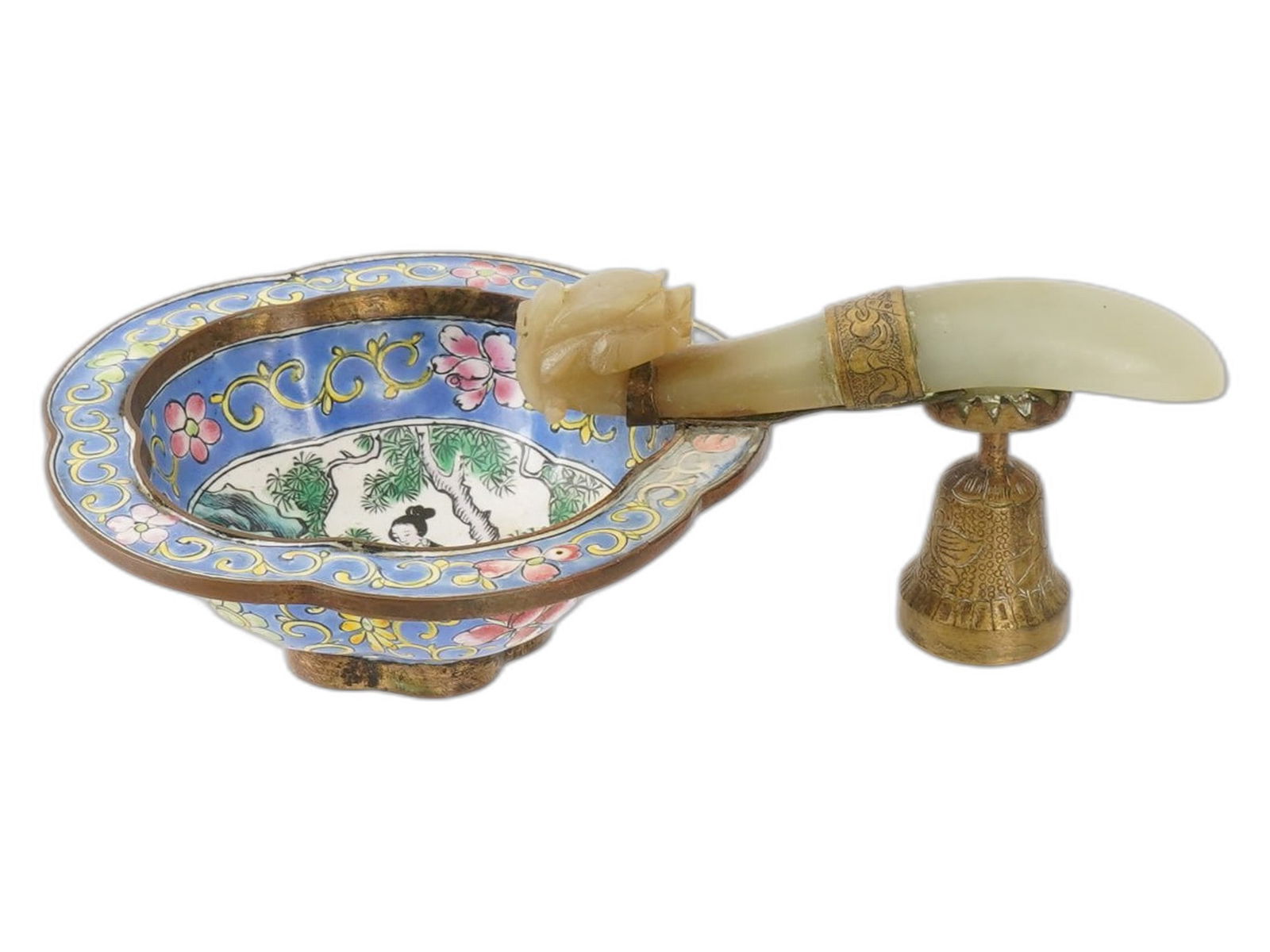 ANTIQUE CHINESE ENAMELED BRASS BOWL WITH JADE HANDLE: An antique Chinese hand enameled brass bowl with a jade belt hook handle, likely dating to the late Qing Dynasty. The handle is a repurposed jade belt hook, hand carved of jade and features a dragons