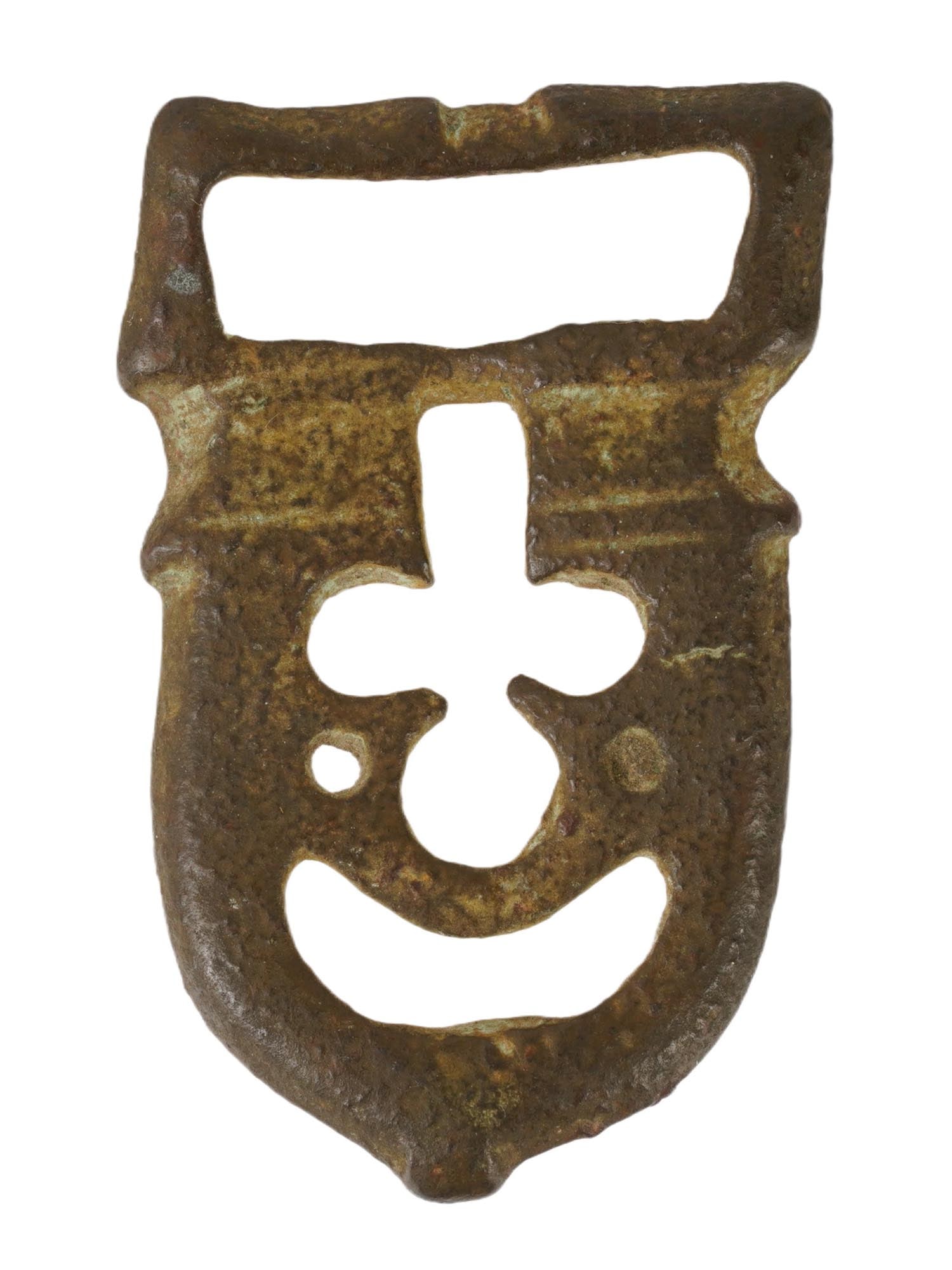 RARE ANCIENT BYZANTINE BRONZE BELT BUCKLE OF MASK FORM: A rare ancient Byzantine bronze belt buckle, dating circa 400 to 600 AD, cast in a theatrical mask form and engraved with a cross motif reflecting early Christian symbolism. Ancient Artifacts And Arch