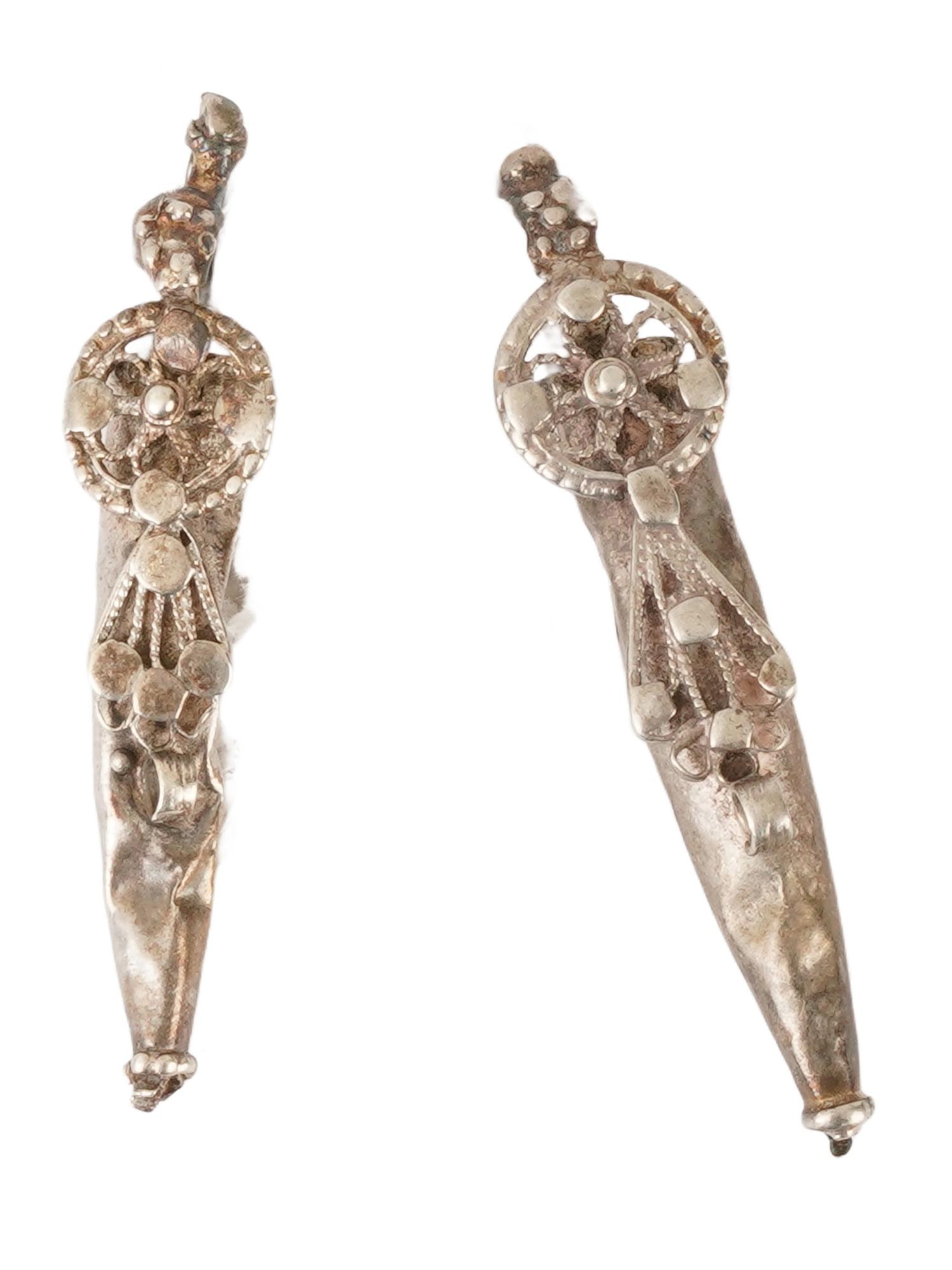 TWO ANCIENT BYZANTINE SILVER PENDANTS 400 TO 600 AD: A lot of two ancient Byzantine silver conical pendants. Circa 400 to 600 AD. Each pendant features a distinctive elongated conical shape. They are adorned with a central circular wheel element at the