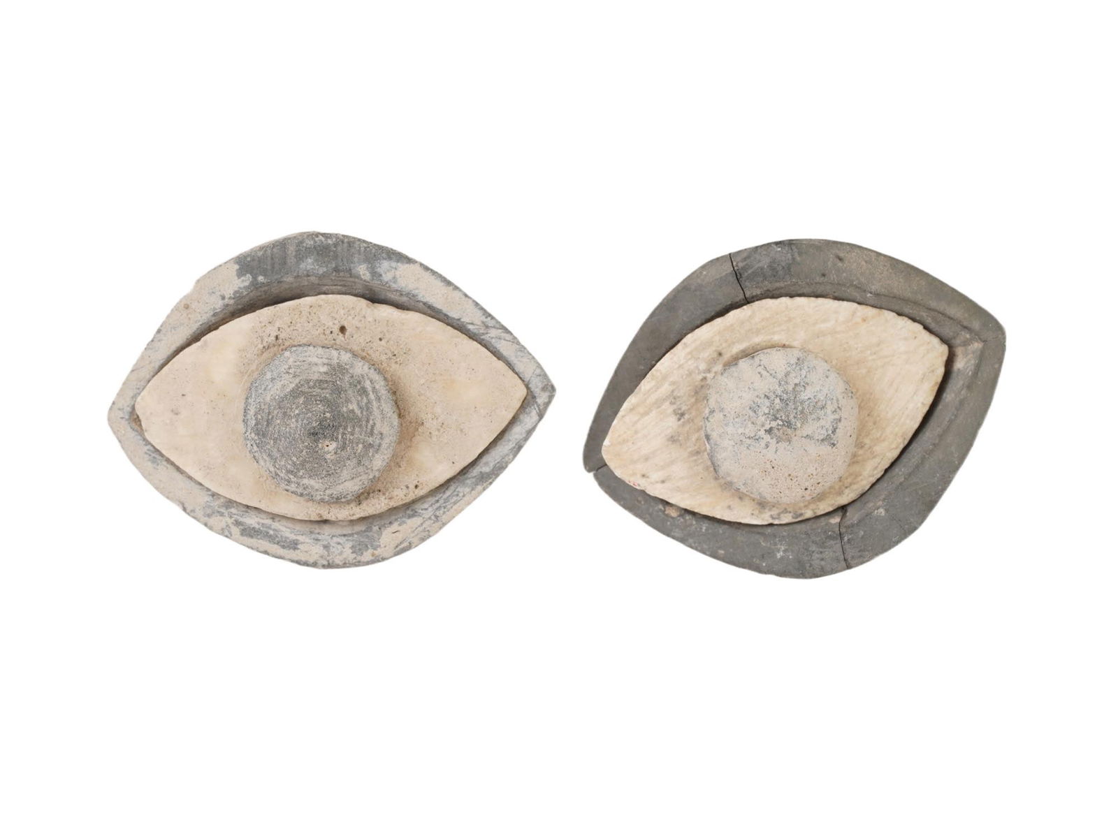 PAIR OF ANCIENT CARVED STEATITE EYES OF SEPARATE PARTS: A pair of ancient carved steatite eyes. Each eye consists of three separate parts: the iris, sclera, and eyelids, showcasing intricate craftsmanship and attention to detail. Ancient Carved Ritual And
