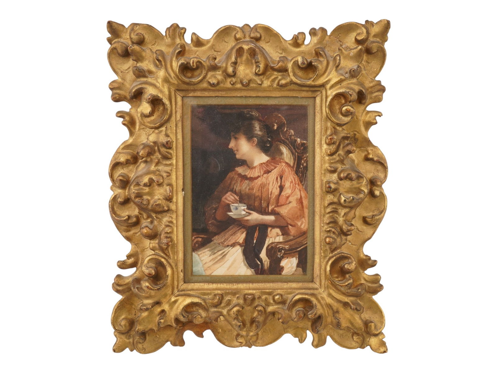 ANTIQUE EUROPEAN SCHOOL WATERCOLOR MINIATURE PAINTING: An antique European School watercolor miniature painting. The miniature depicts a portrait of a seated woman holding a cup of tea or coffee. It is framed in a lush, gold-toned baroque frame. Unsigned.