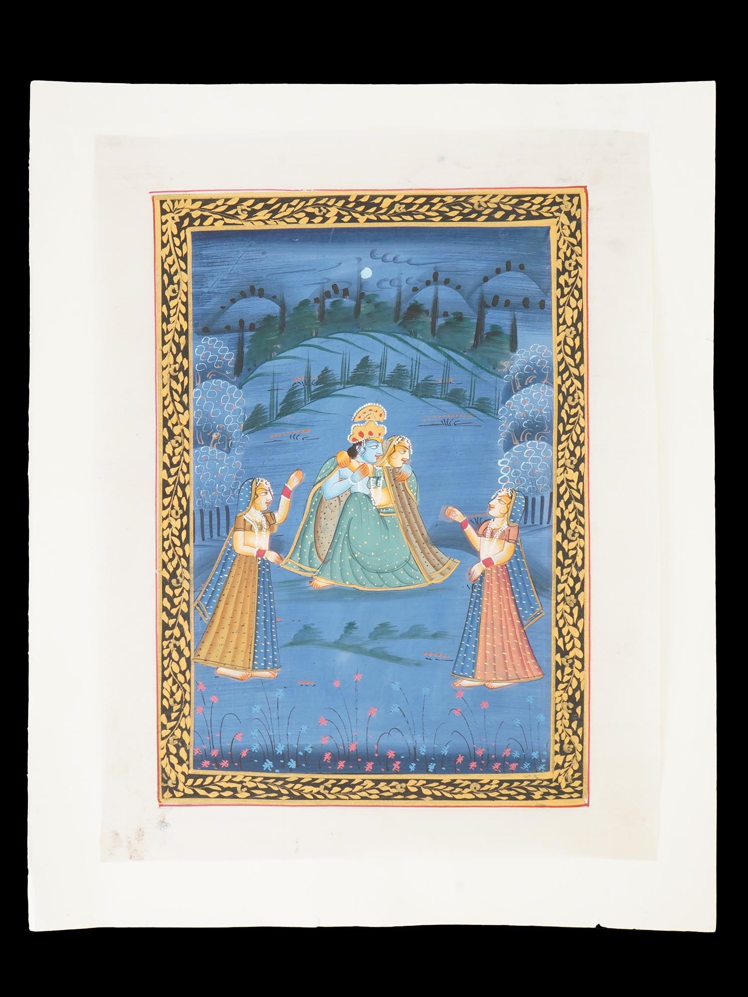 INDIAN RAJASTHANI SCHOOL OIL MINI PAINTING ON SILK: An antique Indian Rajasthani School Mughal Art mixed media miniature painting on paper depicting a scene with Krishna and Radha and two Gopis in the Emperor garden painted in bold colors and with fine